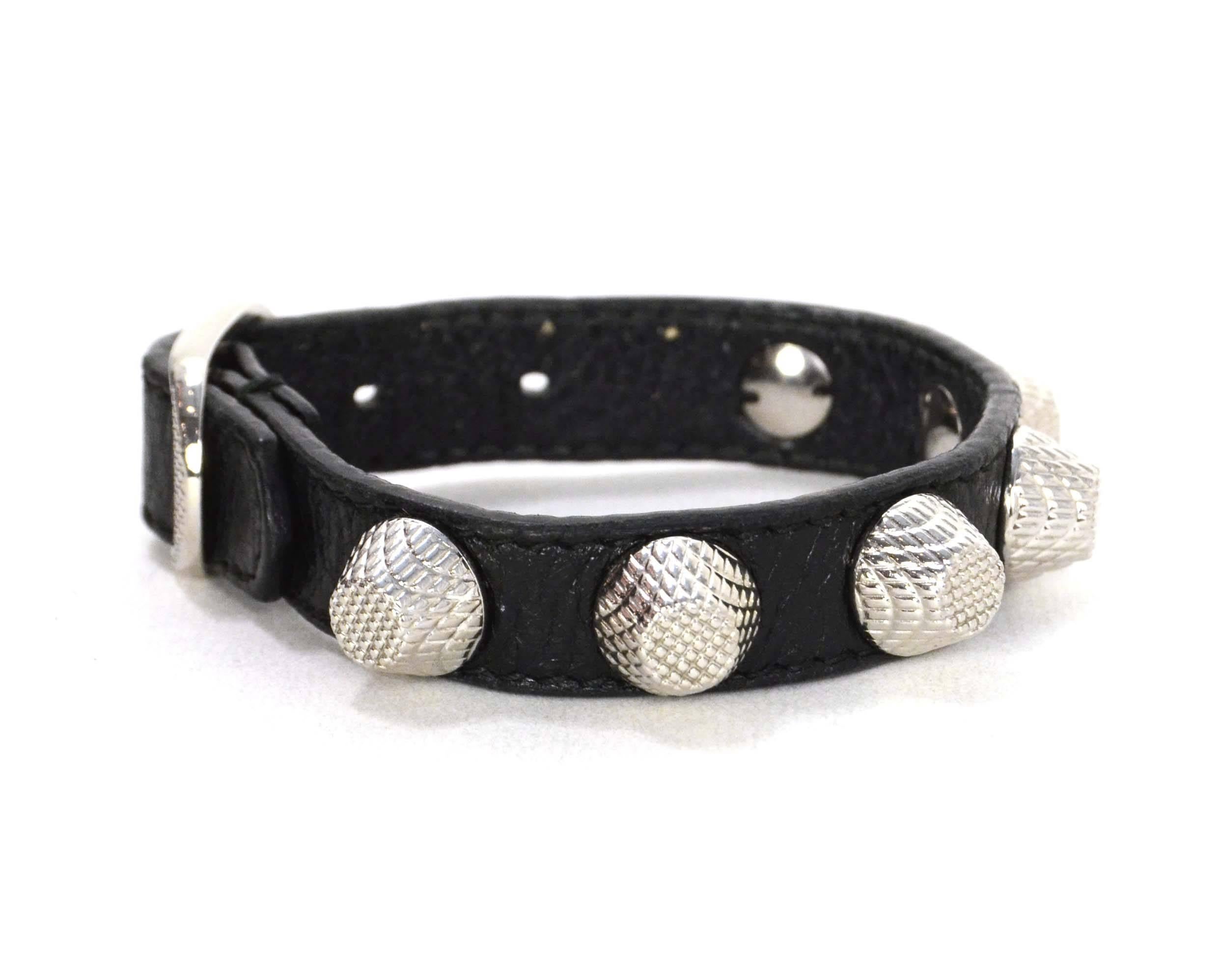 Balenciaga Black Leather  Studded Bracelet
Features distressed leather
Color: Black and silvertone
Hardware: Silvertone
Materials: Distressed leather and metal
Closure: Buckle and notch closure
Retail Price: $245 + tax
Overall Condition: