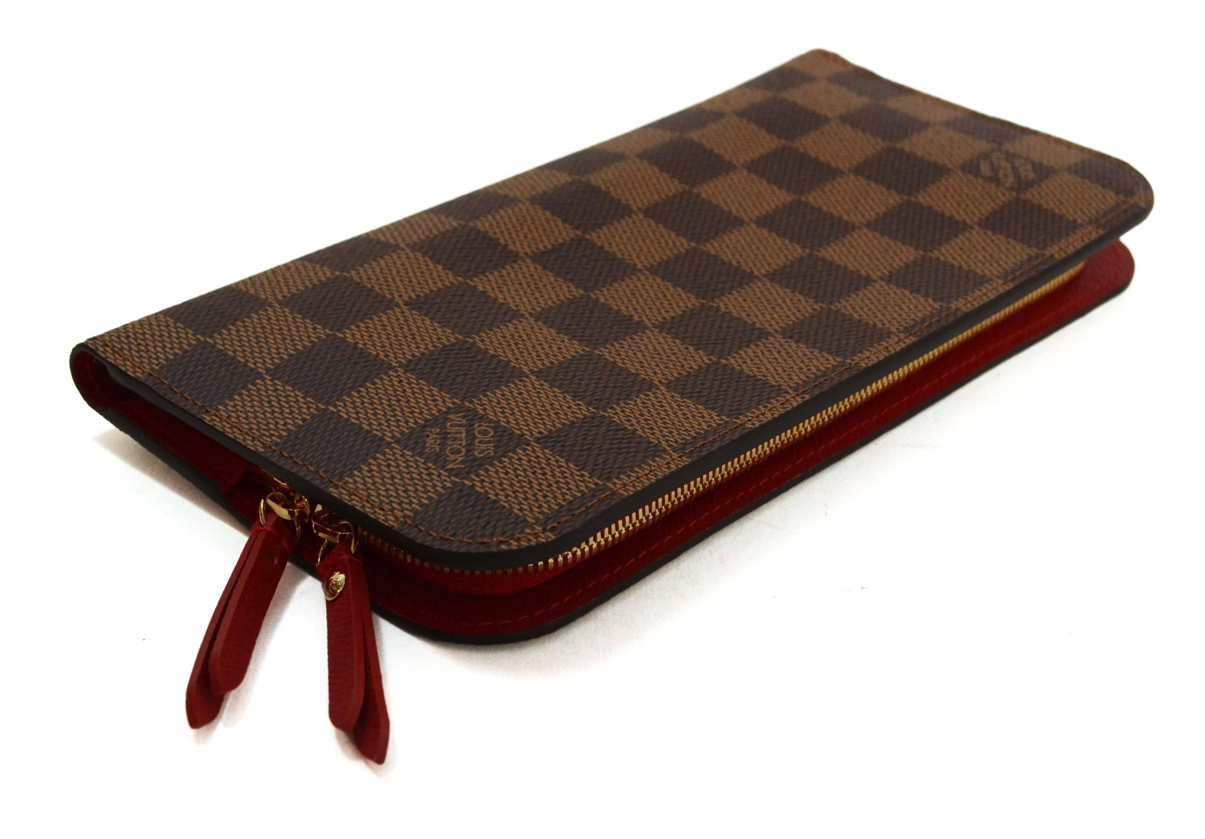 Louis Vuitton Damier Insolite Snap Wallet With Red Interior
Features red leather interior

    Made In: Spain

    Year of Production: 2015

    Color: Damier Ebene, red

    Hardware: Gold

    Materials: Coated canvas, leather

   