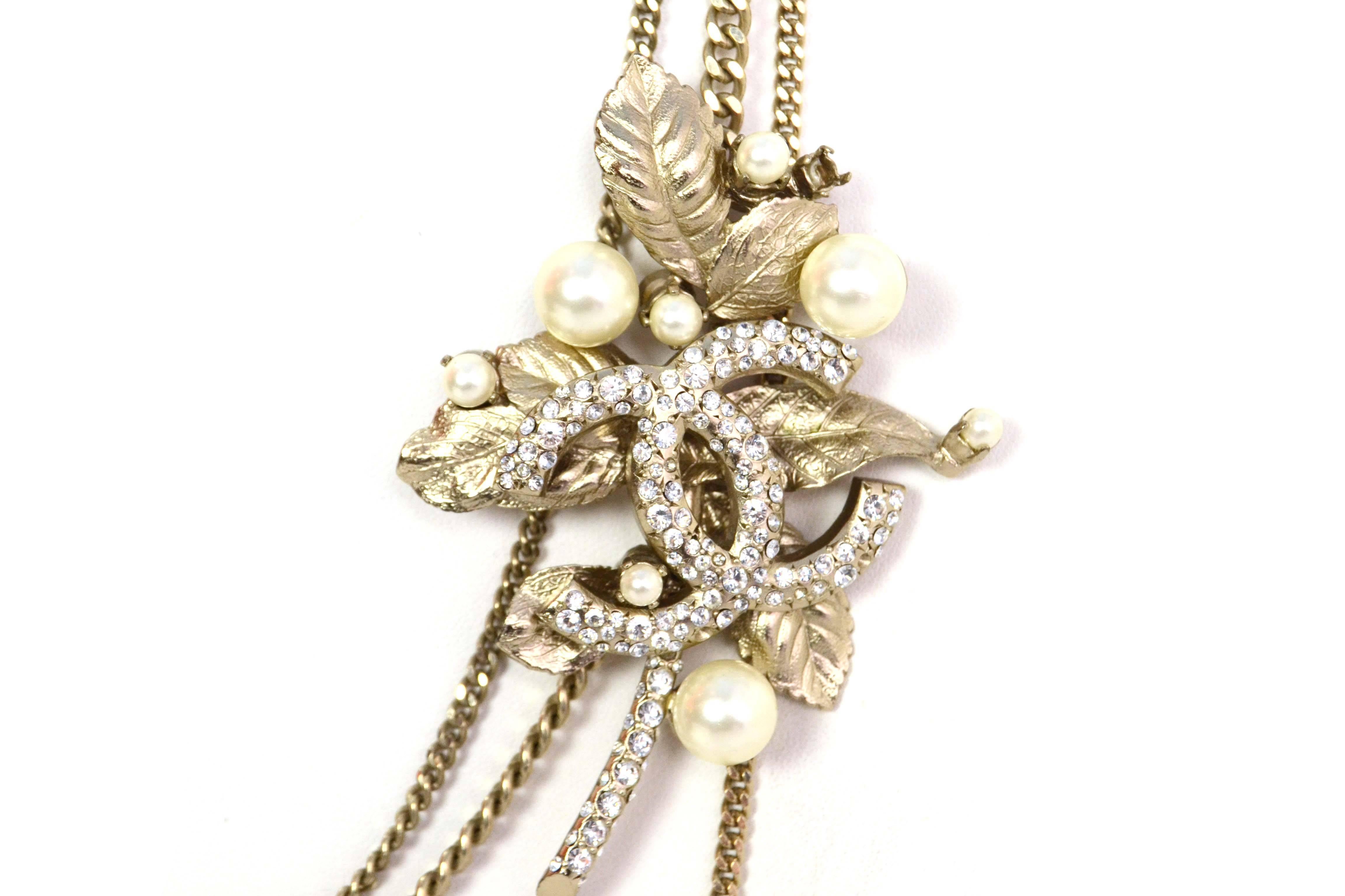 Chanel Pale Gold Pearl & Crystal CC Multi-Strand Necklace 
Features large crystal CC and tree branch pendant with large and small pearls throughout
Made In: France
Year of Production: 2004
Color: Pale goldtone and ivory
Materials: Metal, faux