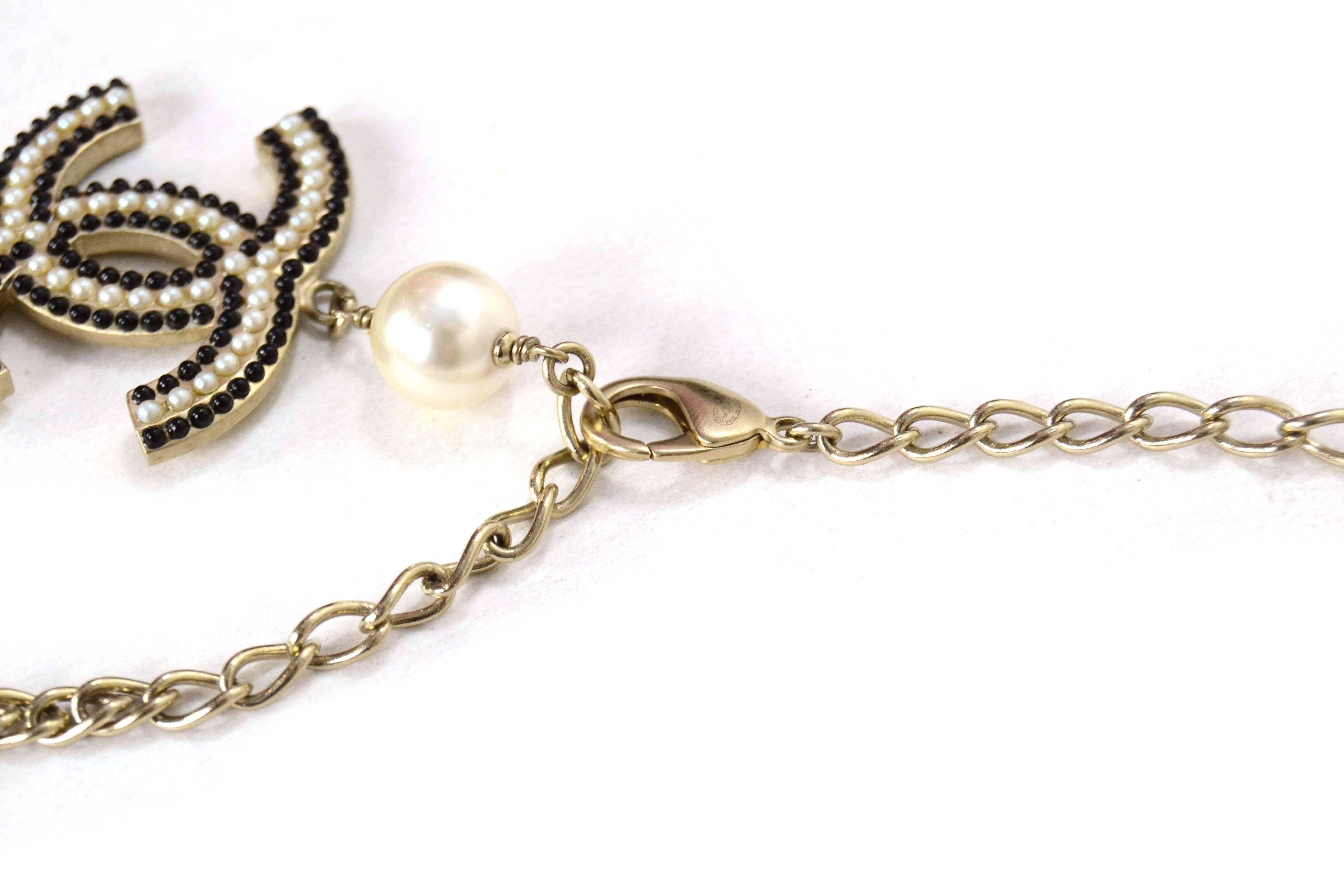 Chanel Pale Gold Multi-Strand Carousel Necklace 
Features one large CC pendant, three small CC pendants and faux pearls and black beads throughout
Made In: Italy
Year of Production: 2008
Color: Pale gold, ivory and black
Materials: Metal, faux