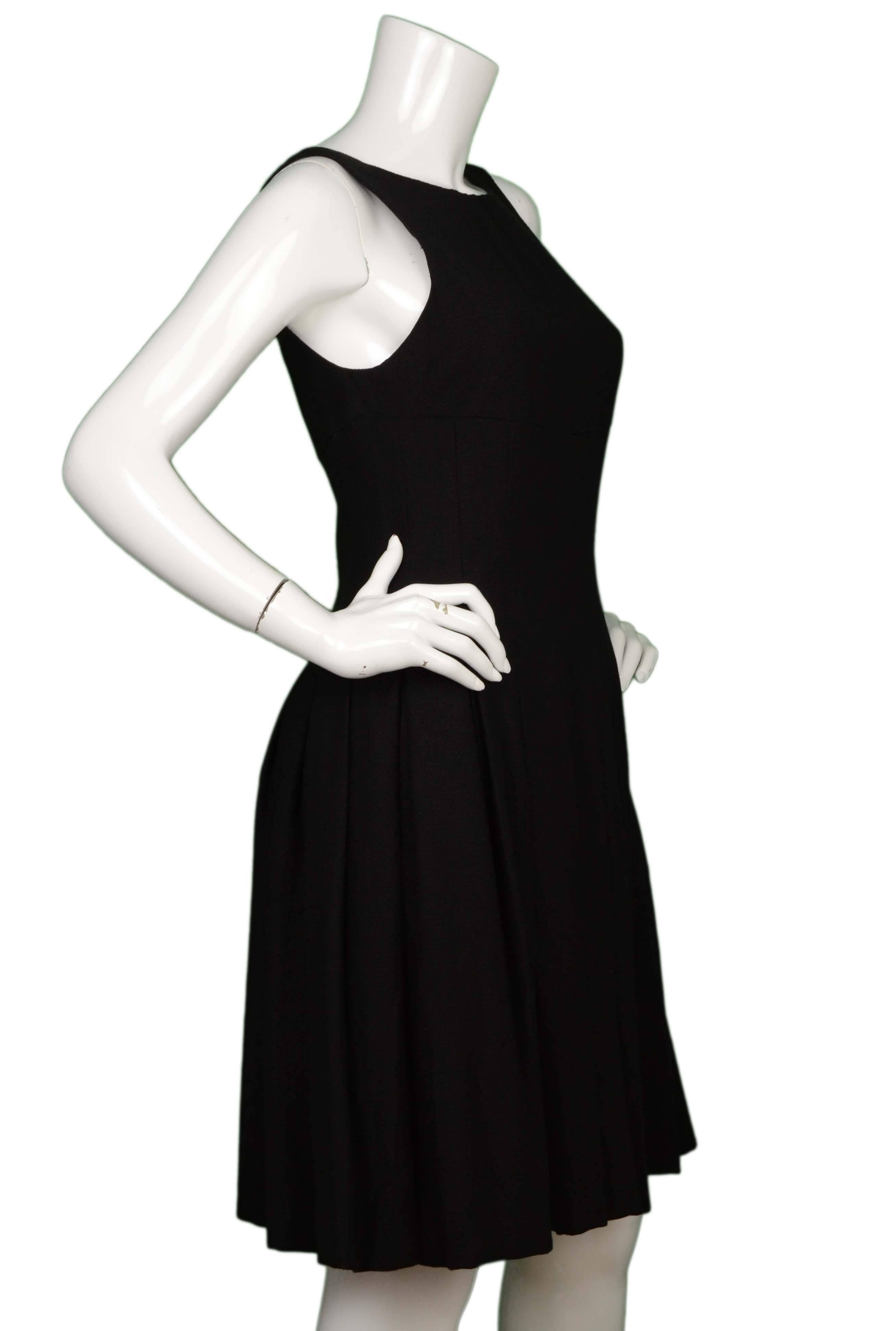 Chanel Black Wool Sleeveless Pleated Dress 

Made In: France
Year of Production: 2007
Color: Black
Composition: 53% wool, 31% silk, 16% rayon
Lining: Black, 100% silk
Closure/Opening: Back center zip up
Exterior Pockets: None
Interior