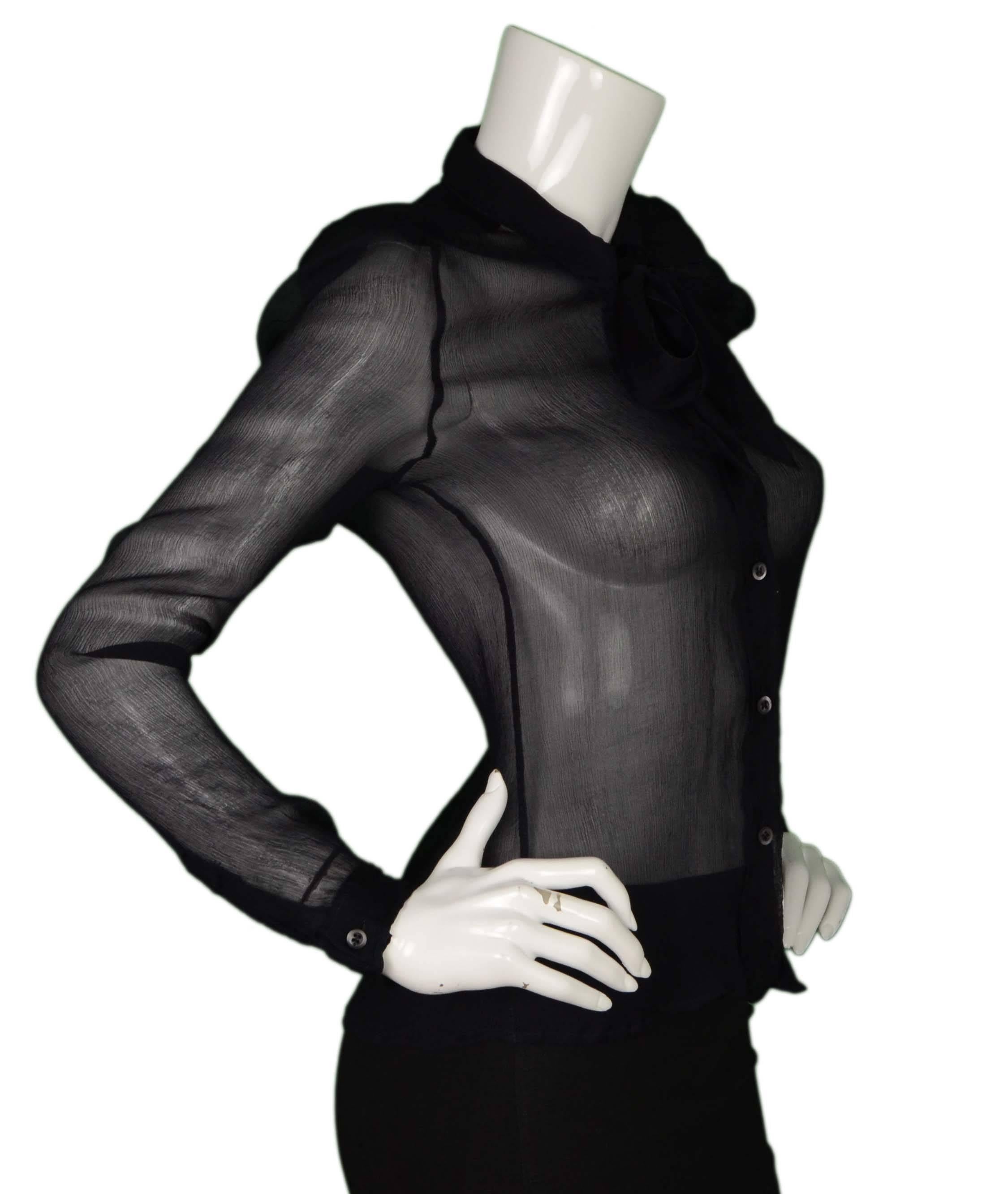 Prada Black Sheer Silk Long Sleeve Blouse
Features tie at neck
Made In: Italy
Color: Black
Composition: 100% silk 
Lining: None
Closure/Opening: Button down front with tie at neckline
Exterior Pockets: None
Interior Pockets: None
Overall
