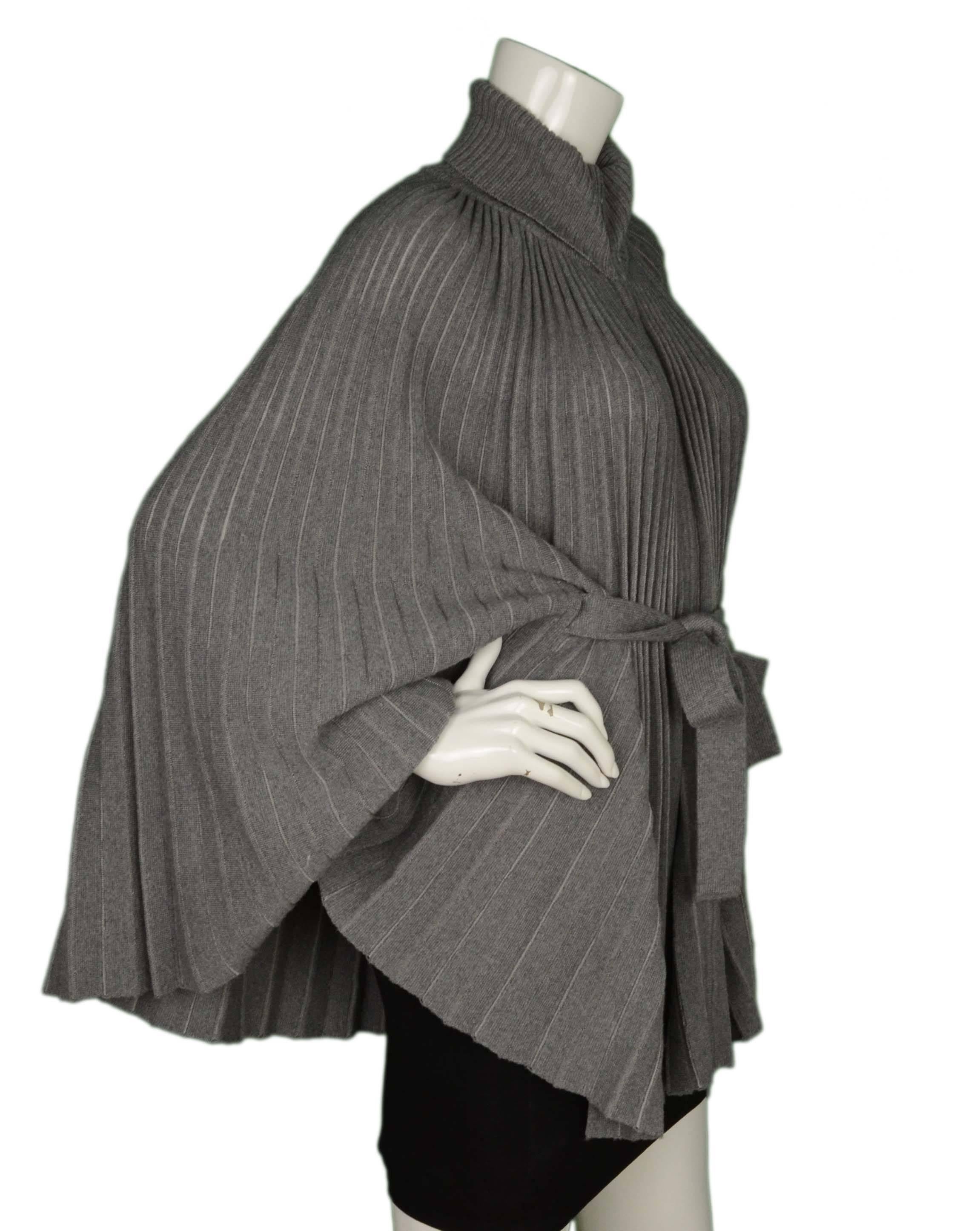 Valentino Grey Wool Pleated Cape
Features waist tie
Made In: Italy
Color: Grey
Composition: Not given- believed to be a wool blend
Lining: None
Closure/Opening: Double zipper closure
Exterior Pockets: None
Interior Pockets: None
Overall