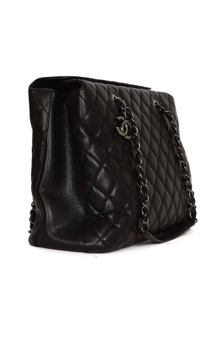 Chanel '15 Black Quilted Caviar Shopper Tote 
Features silvertone hanging CC charm on front
Made In: Italy
Year of Production: 2011
Color: Black
Hardware: Oxidized silvertone
Materials: Caviar leather
Lining: Black grosgrain
Closure/Opening: