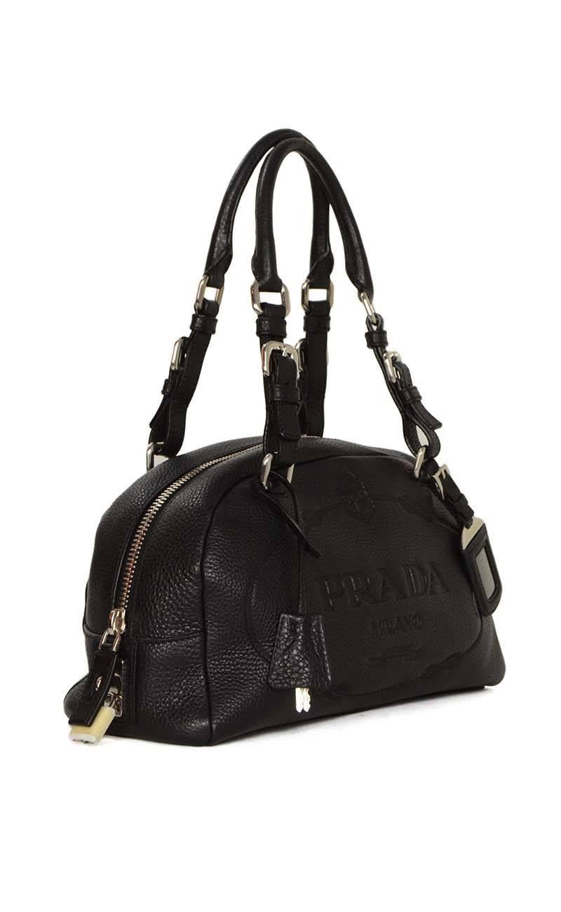Prada Black Leather Bowler Bag 
Features Prada logo stamped on front panel of bag
Made In: Italy
Year of Production: 2005
Color: Black
Hardware: Silvertone
Materials: Leather
Lining: Black, Prada logoed textile
Closure/Opening: Zip around