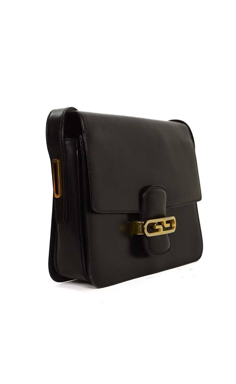 Gucci Vintage Black Leather Shoulder Bag 
Features goldtone GG's on front flap top
Made In: Italy
Color: Black
Hardware: Goldtone
Materials: Leather
Lining: Black leather
Closure/Opening: Flap top with notch that goes into gold GG