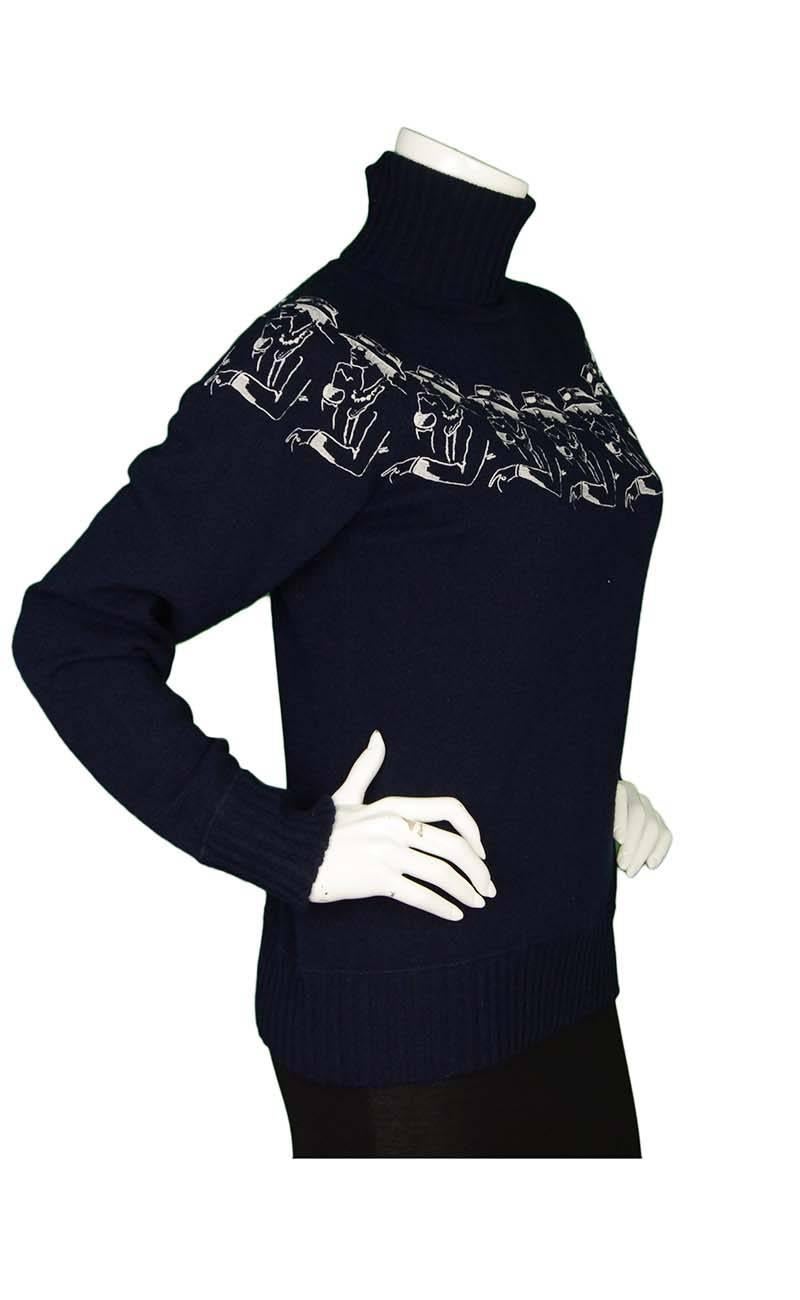 Chanel Navy Cashmere Turtleneck Sweater 
Features white stitched Coco design throughout top of sweater
Made In: Italy
Color: Navy and white
Composition: 100% cashmere
Lining: None
Closure/Opening: Pull over
Exterior Pockets: None
Interior