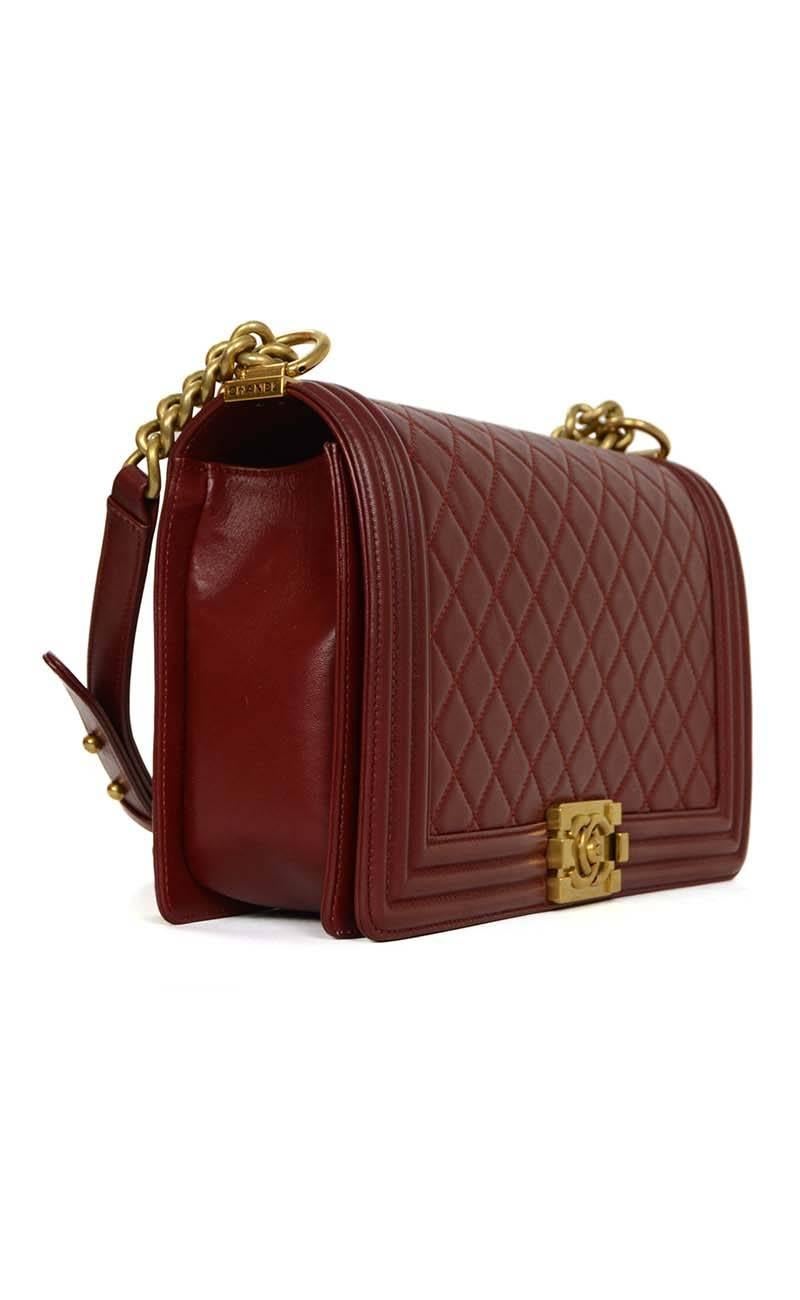Chanel '15 Burgundy Leather New Medium Boy Bag 
Features adjustable shoulder strap
Made In: France
Year of Production: 2015
Color: Burgundy
Hardware: Goldtone
Materials: Leather
Lining: Burgundy grosgrain 
Closure/Opening: Flap top with CC