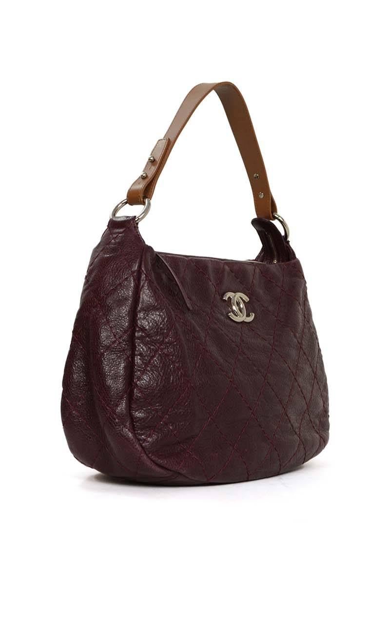 Chanel Plum Distressed Leather 'On the Road' Hobo Bag 
Features tan leather shoulder strap
Made In: Italy
Year of Production: 2011
Color: Plum and tan
Hardware: Silvertone
Materials: Leather and distressed leather
Lining: Plum satin and