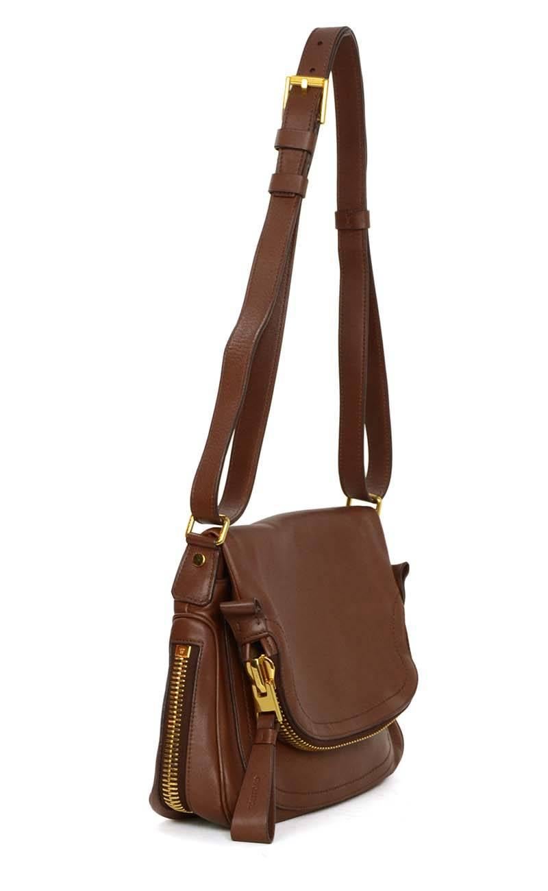 Tom Ford Brown Leather 'Jennifer Aniston' Crossbody Bag 
Features expandable bottom with zipper opening
Made In: Italy
Color: Brown
Hardware: Goldtone
Materials: Leather and metal
Lining: Taupe suede
Closure/Opening: Flap top
Exterior