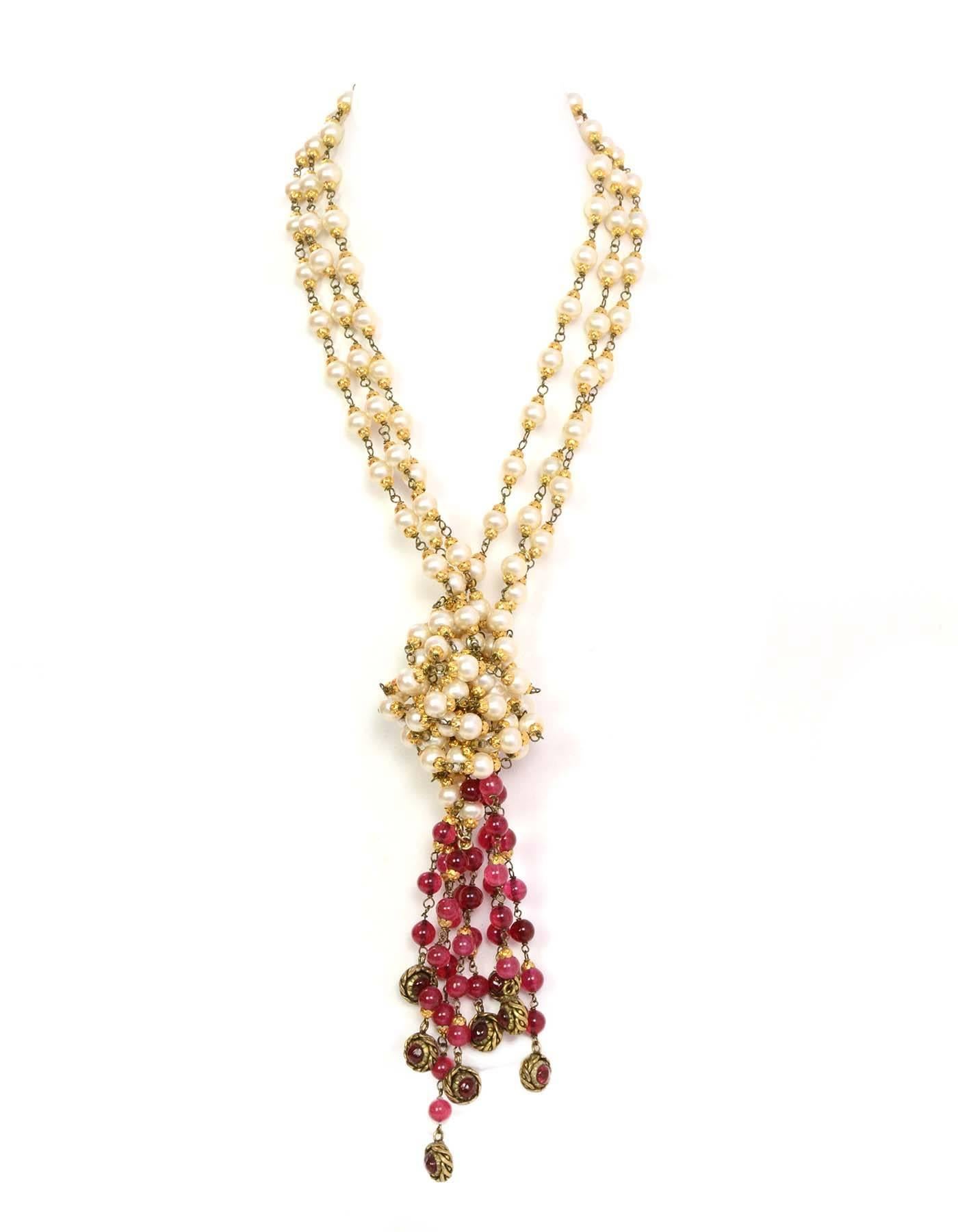 CHANEL Three Strand Long Faux Pearl Lariat Necklace W. Red Gripoix Beads 1984

Age: 1984
Made in France
Materials: faux pearls, red gripoix beads, gold cable accents, gold chain links.
Features triple strand long pearl necklace with four red