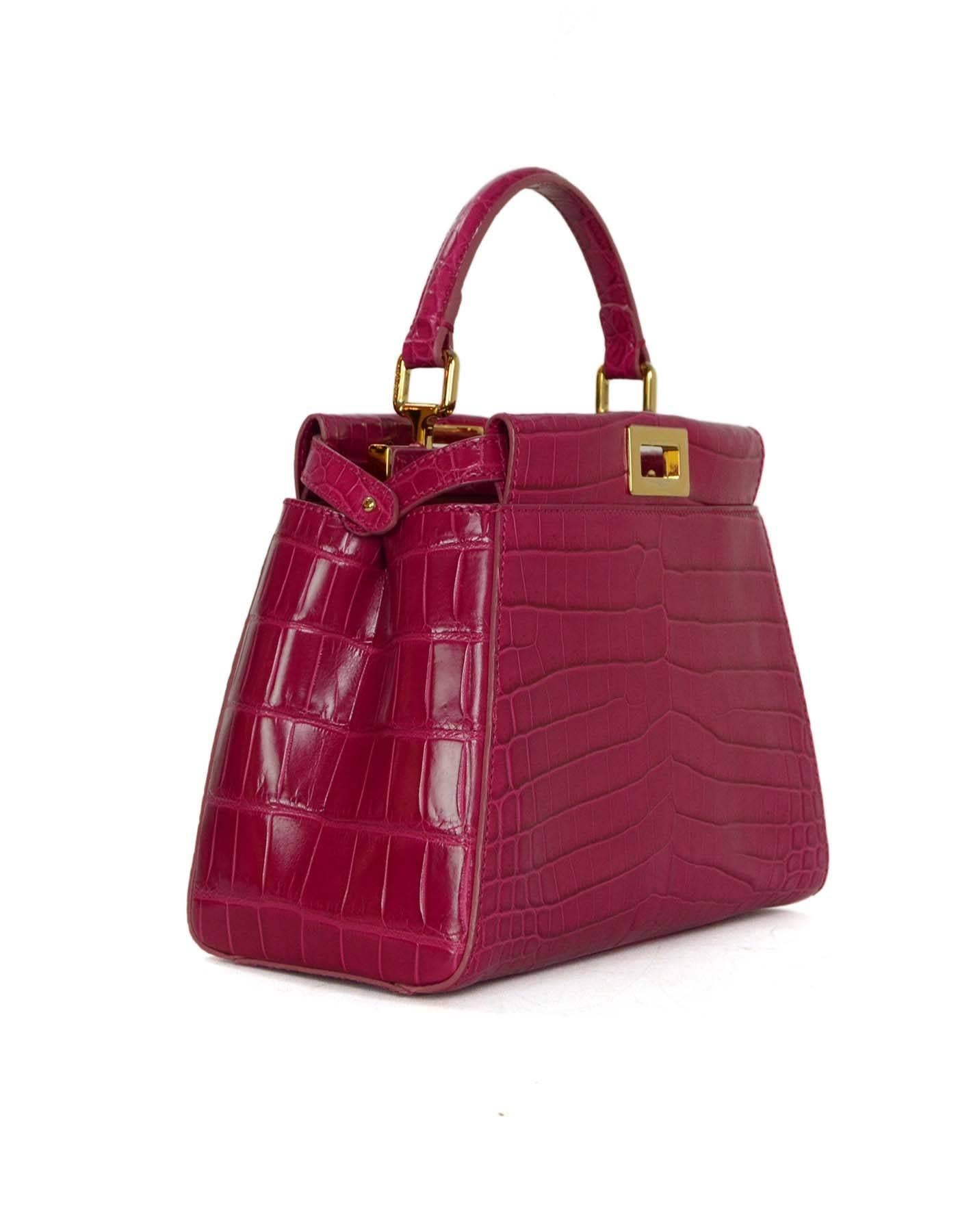 Fendi Hot Pink Glazed Crocodile Mini Peekaboo Bag
Features removable adjustable strap

-Made in: Italy
-Color: Hot pink and goldtone
-Hardware: Goldtone
-Materials: Crocodile skin, leather, and metal
-Lining: Hot pink