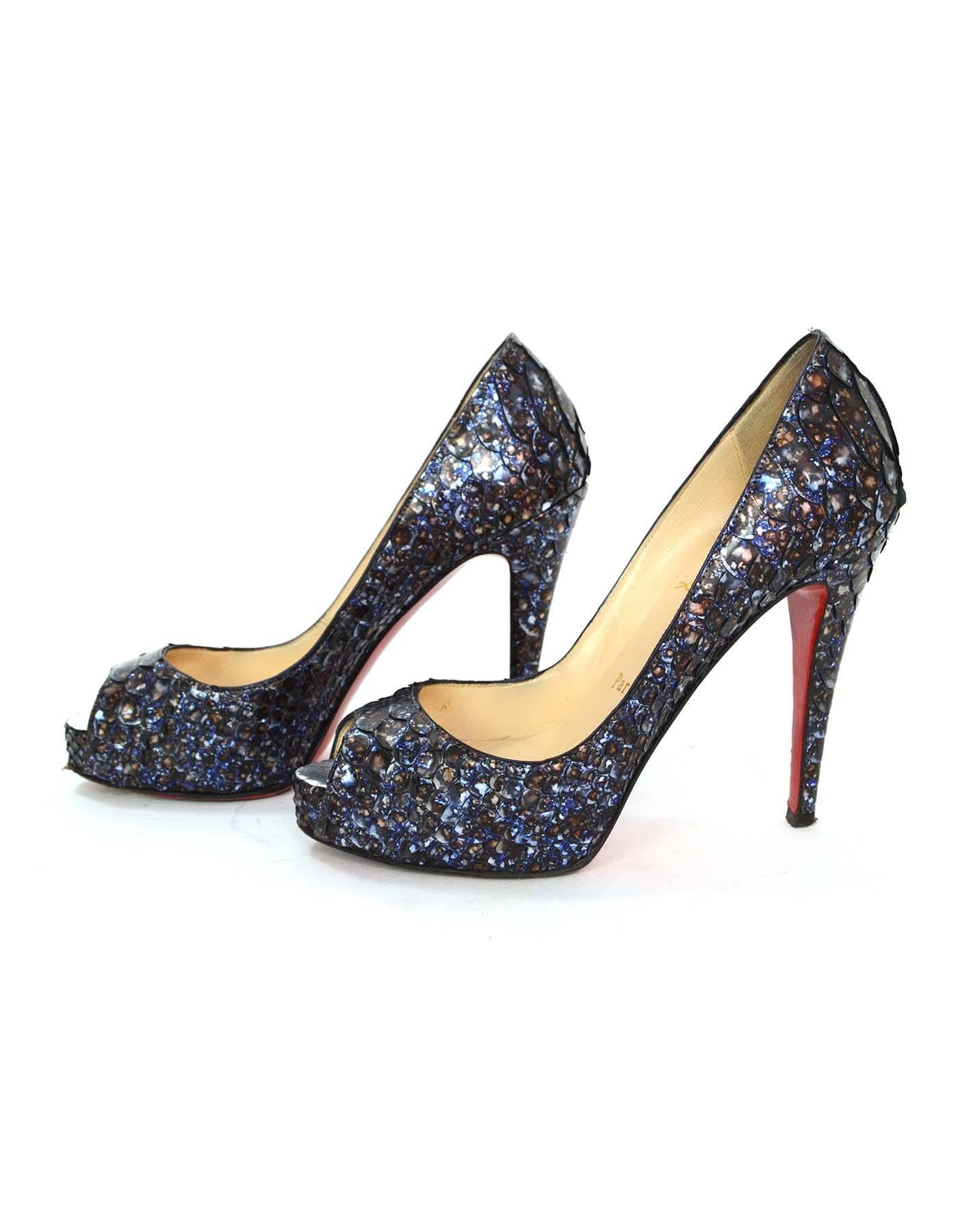 Christian Louboutin Metallic Blue Python 'Very Prive' Peep-Toe Pumps 
Features hidden platform
Made In: Italy
Color: Metallic blue with tones of brown and silver throughout
Materials: Python
Closure/Opening: Slide on
Sole Stamp: Christian