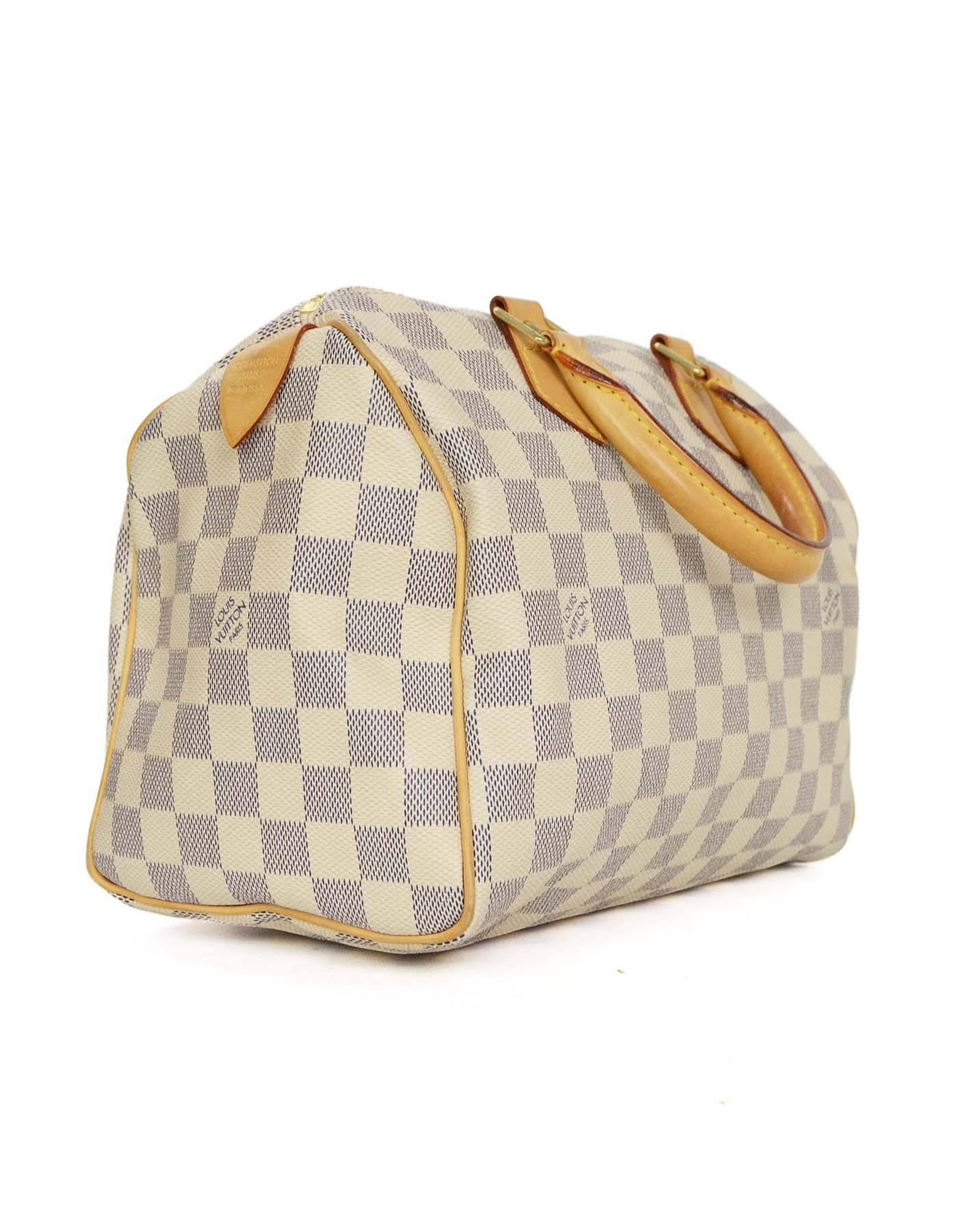Louis Vuitton Damier Azur Speedy 25 Bag 
Features tan leather wrapped handles and leather trim and piping throughout
Made In: U.S.A
Year of Production: 2007
Color: Cream, navy and tan
Hardware: Goldtone
Materials: Coated canvas and