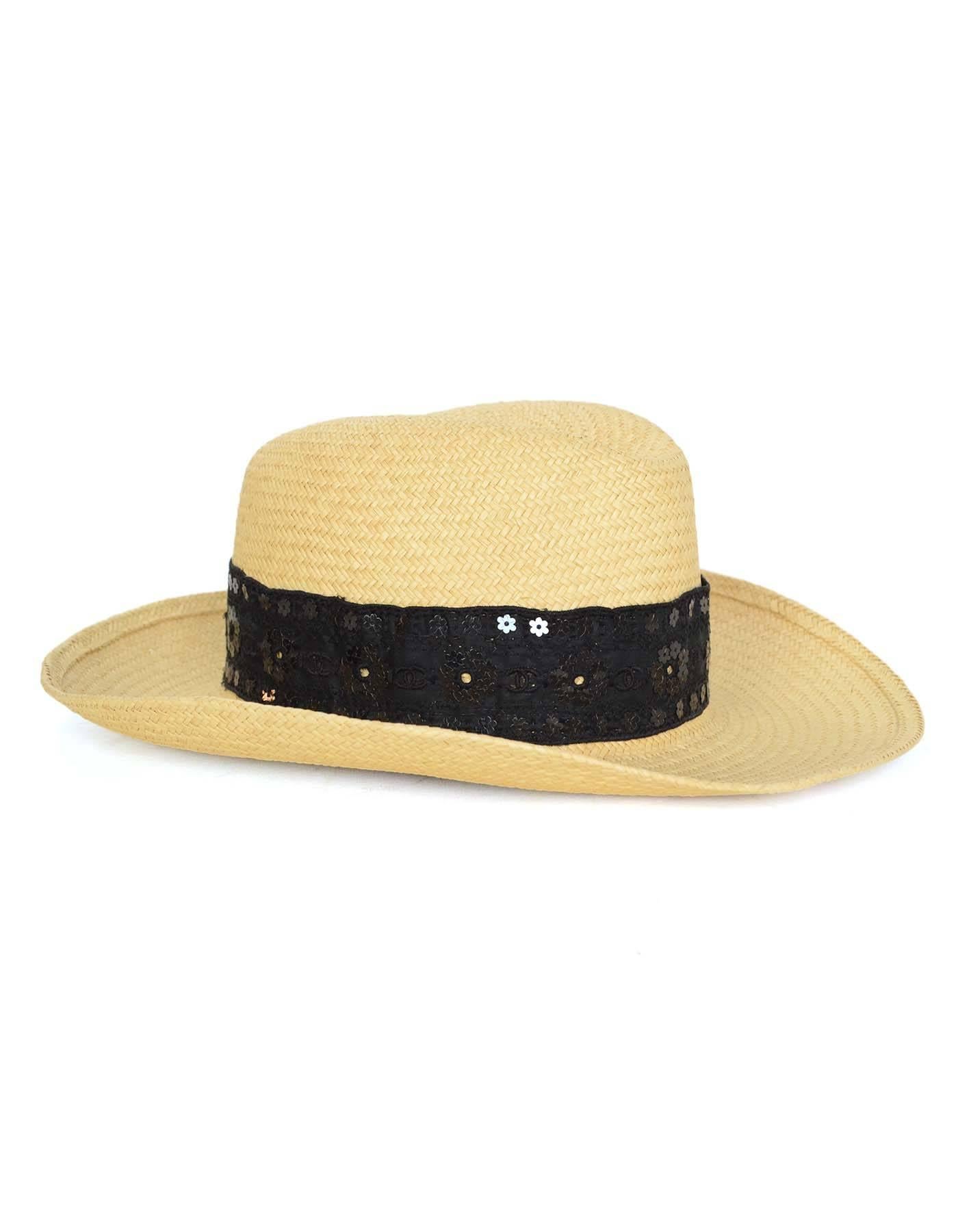 Chanel Natural Straw Panama Hat 
Features black eyelet & sequin ribbon detailing
Made In: France
Year of Production: 2006
Color: Neutral and black
Materials: 100% straw
Closure/Opening: None
Overall Condition: Excellent pre-owned