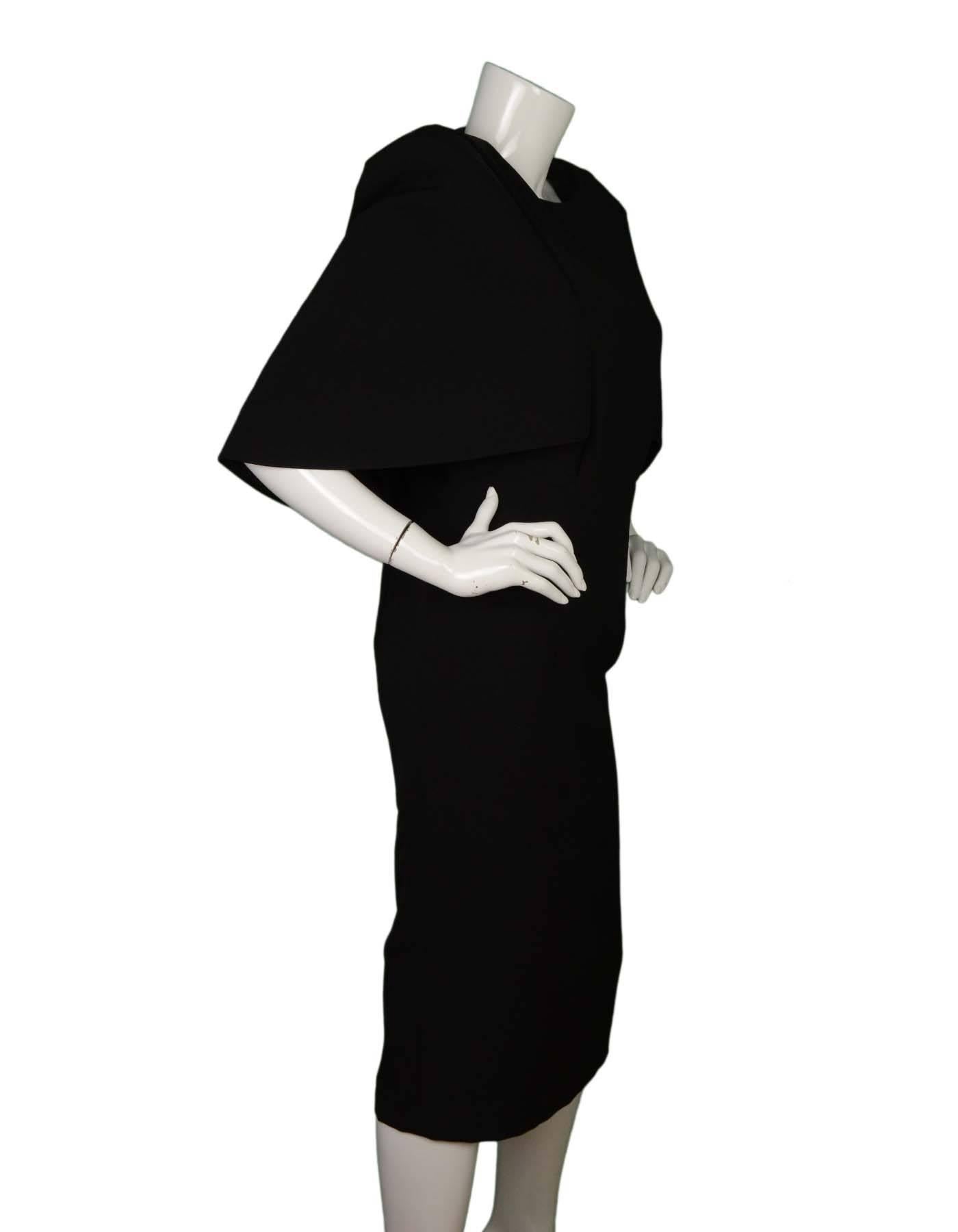 AQ/AQ Black Caped Cocktail Dress 
Features attached cape with shoulder pads for sharp, squared shoulders
Made In: China
Color: Black
Composition: 97% polyester, 3% elastane
Lining: Black, 100% polyester
Closure/Opening: Back center zip