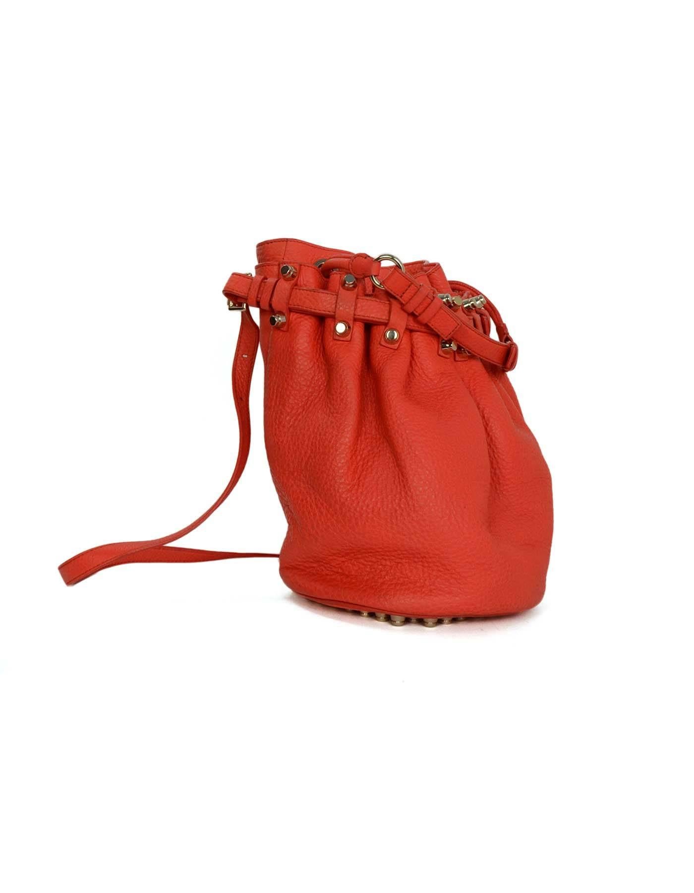Alexander Wang Red Pebbled Leather Diego Bucket Bag 
Features optional shoulder/crossbody strap
Made In: China
Color: Red
Hardware: Silvertone
Materials: Pebbled leather
Lining: Black nylon-blend textile
Closure/Opening: Drawstring style