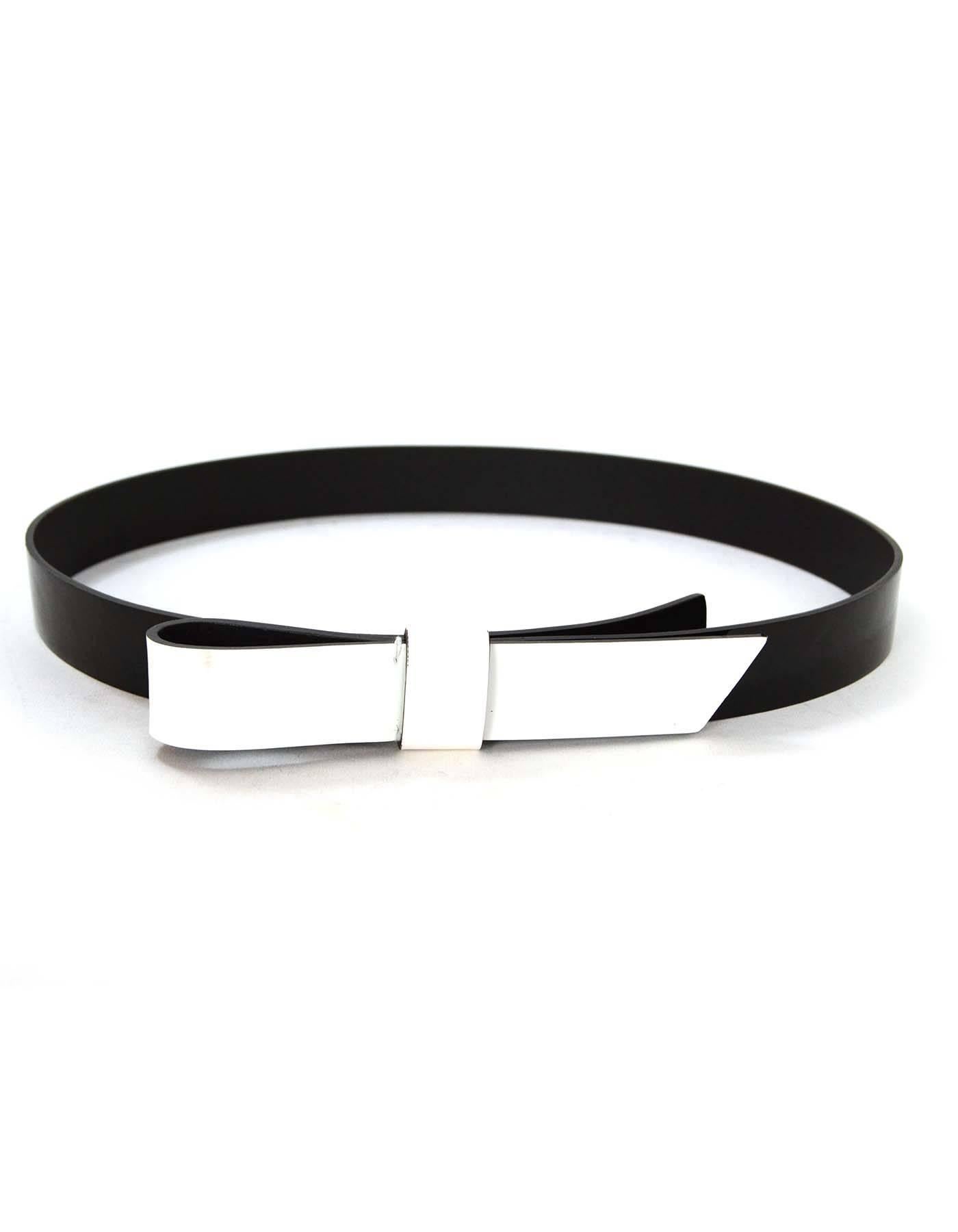 Lanvin Black & White Patent Belt 
Features white patent bow
Made In: Italy
Color: Black and white
Materials: Patent leather
Closure/Opening: Snap buttons
Retail Price: $495 + tax
Overall Condition: Excellent pre-owned condition with the