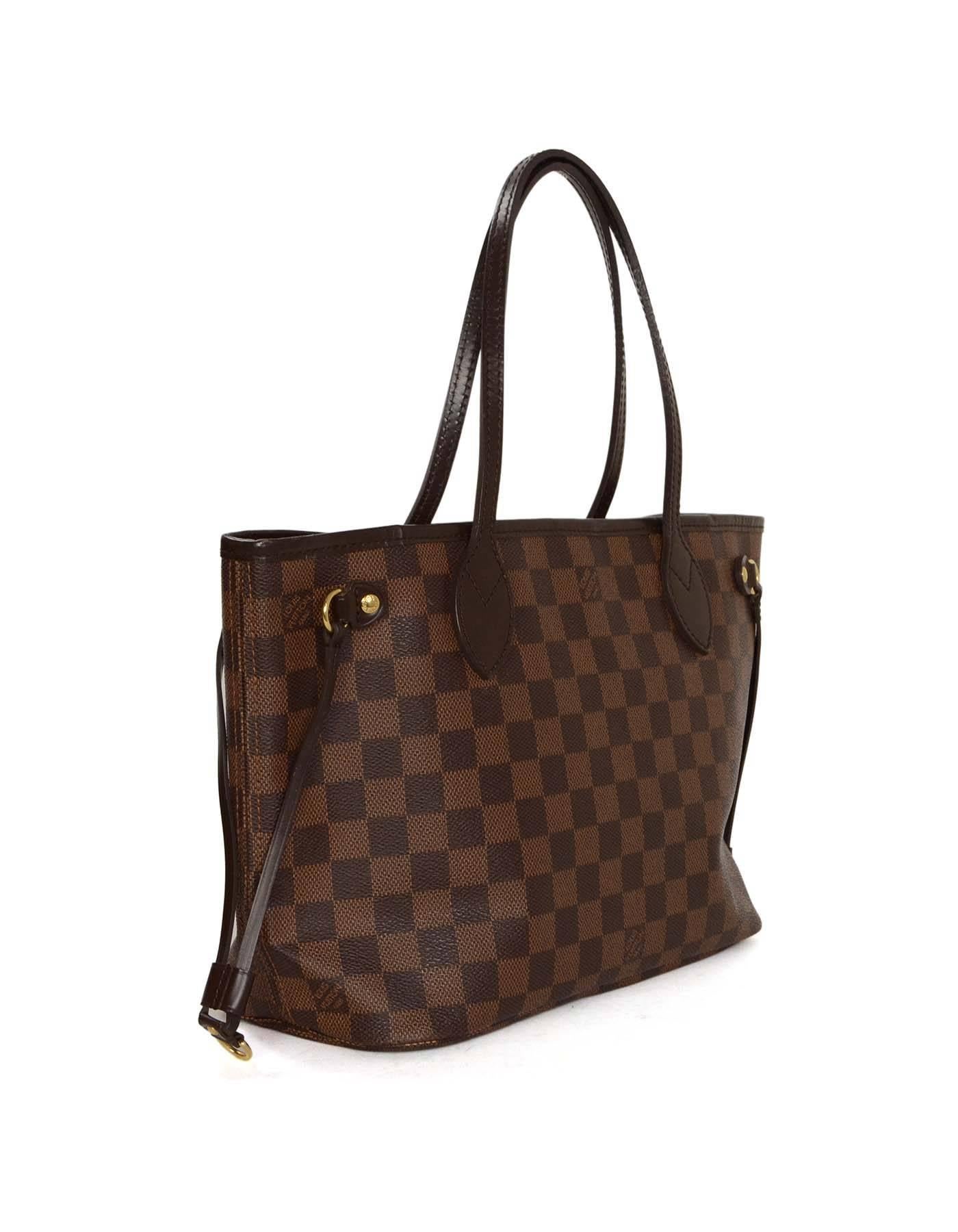 Louis Vuitton Damier Coated Canvas Neverfull PM Tote Bag

-Made In: France
-Year of Production: 2011
-Color: Brown
-Hardware: Goldtone
-Materials: Coated canvas with leather trim
-Closure/Opening: Open with hook closure
-Exterior Pockets: