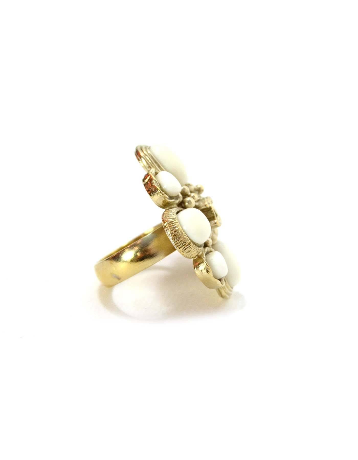 Chanel Gold & White Flower Cocktail Ring 
Features goldtone CC in center of flower
Made In: Italy
Color: Pale gold and white
Materials: Metal and glass
Closure: None
Stamp: 09 CC P
Overall Condition: Excellent pre-owned condition
Size: