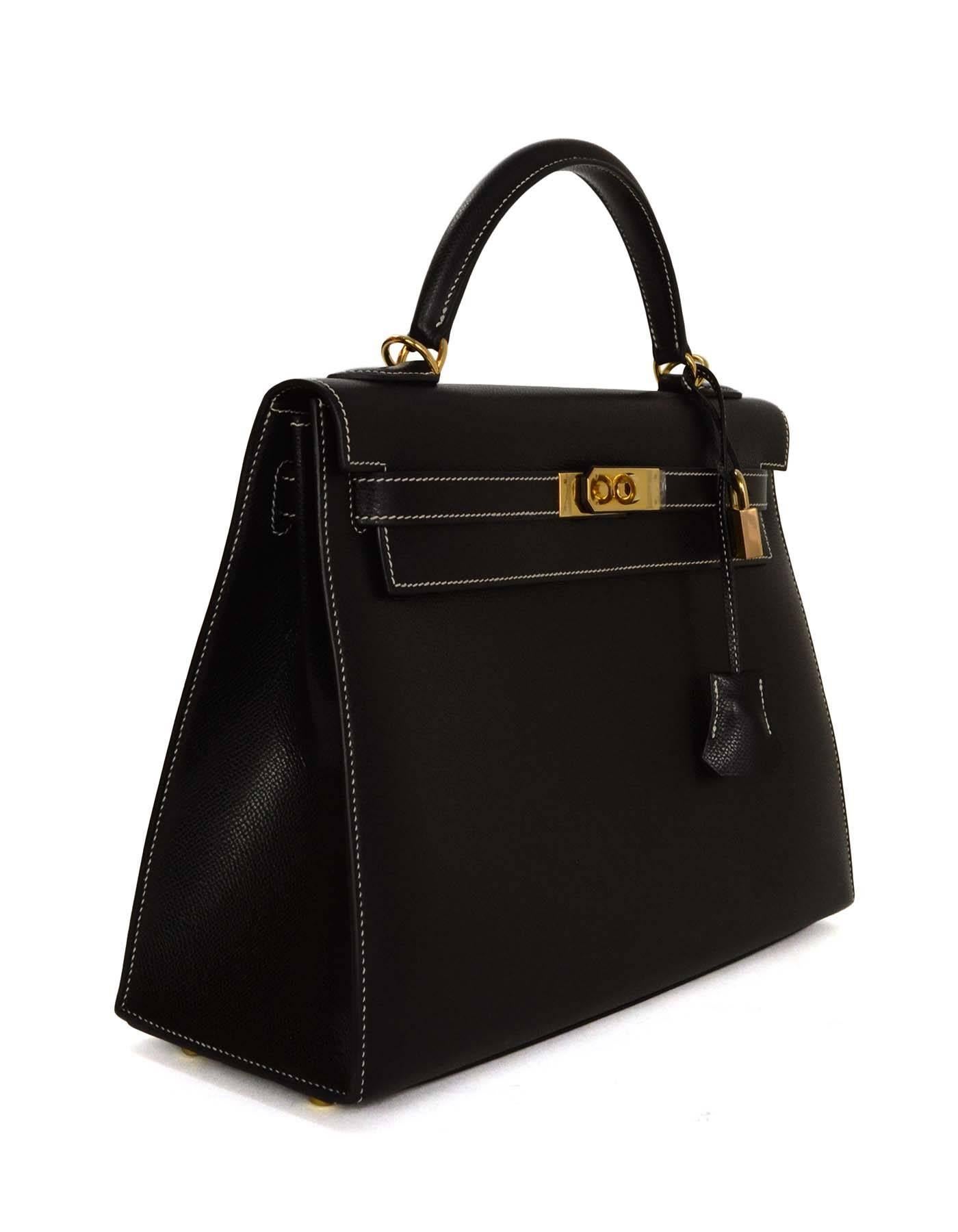 Hermes Black Leather 32cm Rigid Sellier Kelly Bag GHW 
Features optional shoulder strap and white contrast stitching.  This bag is the Sellier/Rigid style so it is a more structured style

-Made in: France
-Year of Production: 2002
-Color: