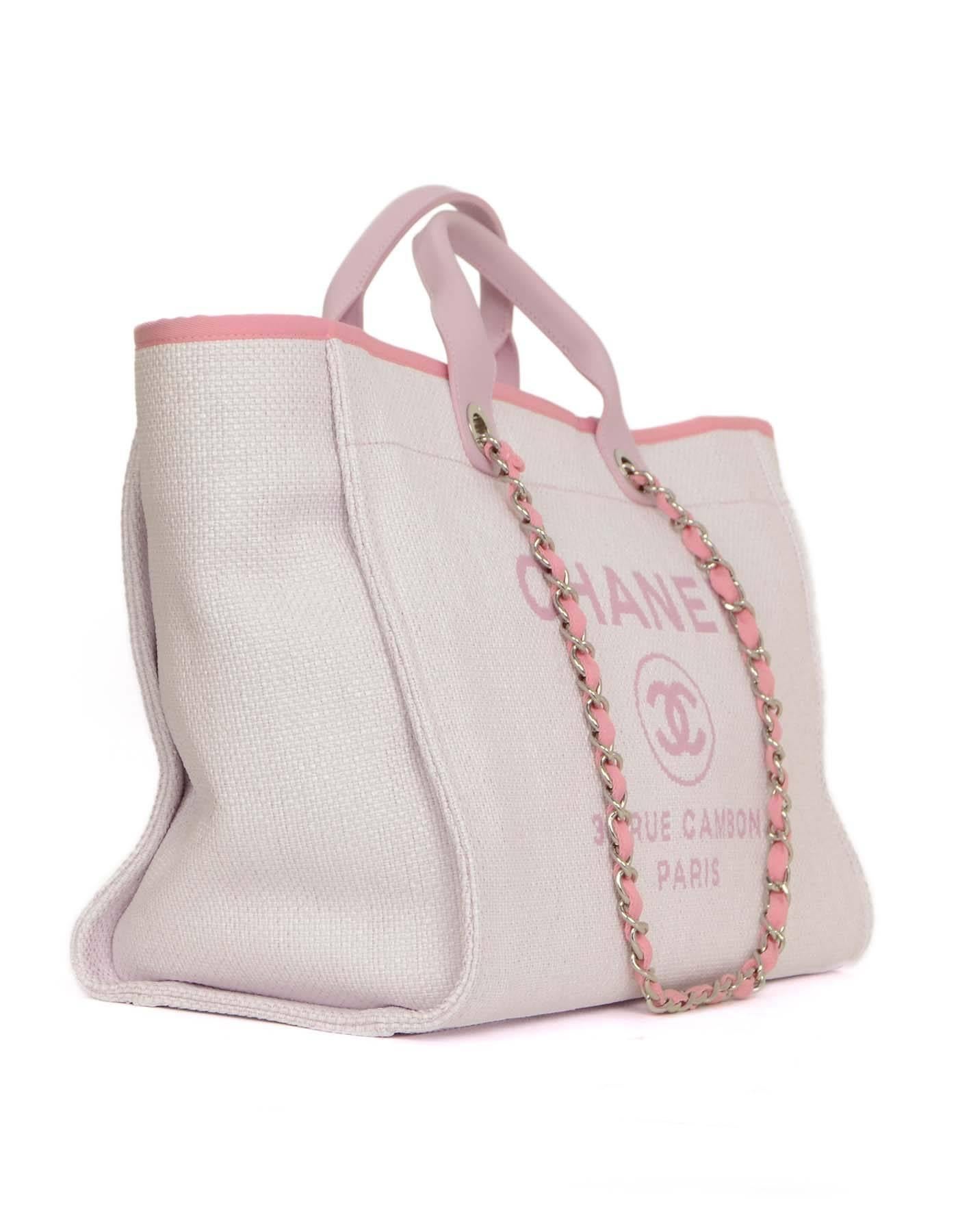 Chanel Pink Canvas Deauville Tote 
Features short pink leather handles and longer chain link pink canvas woven shoulder straps
Made in: Italy
Year of Production: 2015
Color: Pink and ivory
Hardware: Silvertone
Materials: Canvas, leather and