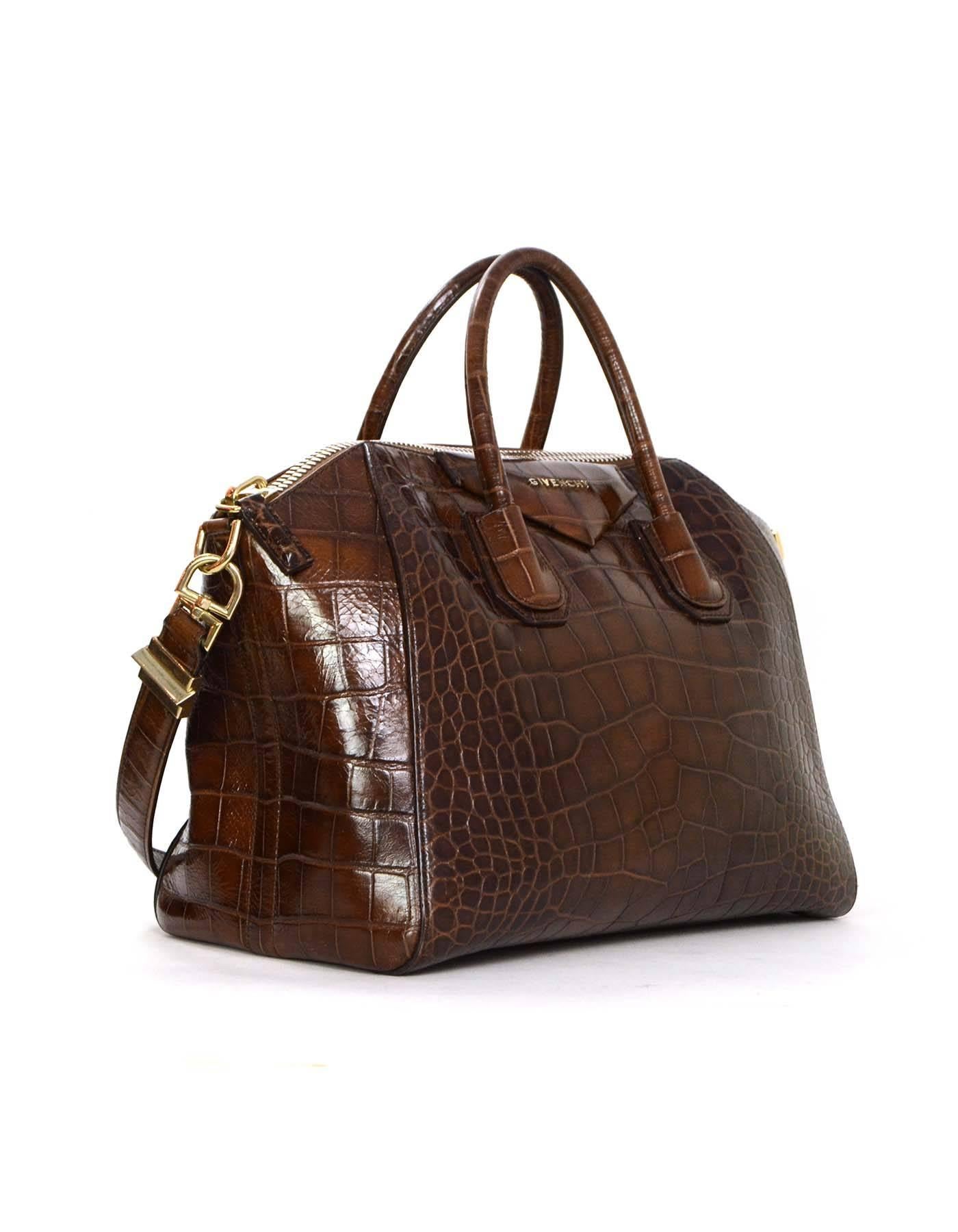 Givenchy Brown Croc Embossed Medium Antigona Bag
Features optional shoulder strap
Made In: Italy
Year of Production: 2012
Color: Brown
Hardware: Goldtone
Materials: Croc embossed leather
Lining: Black canvas
Closure/Opening: Zip across