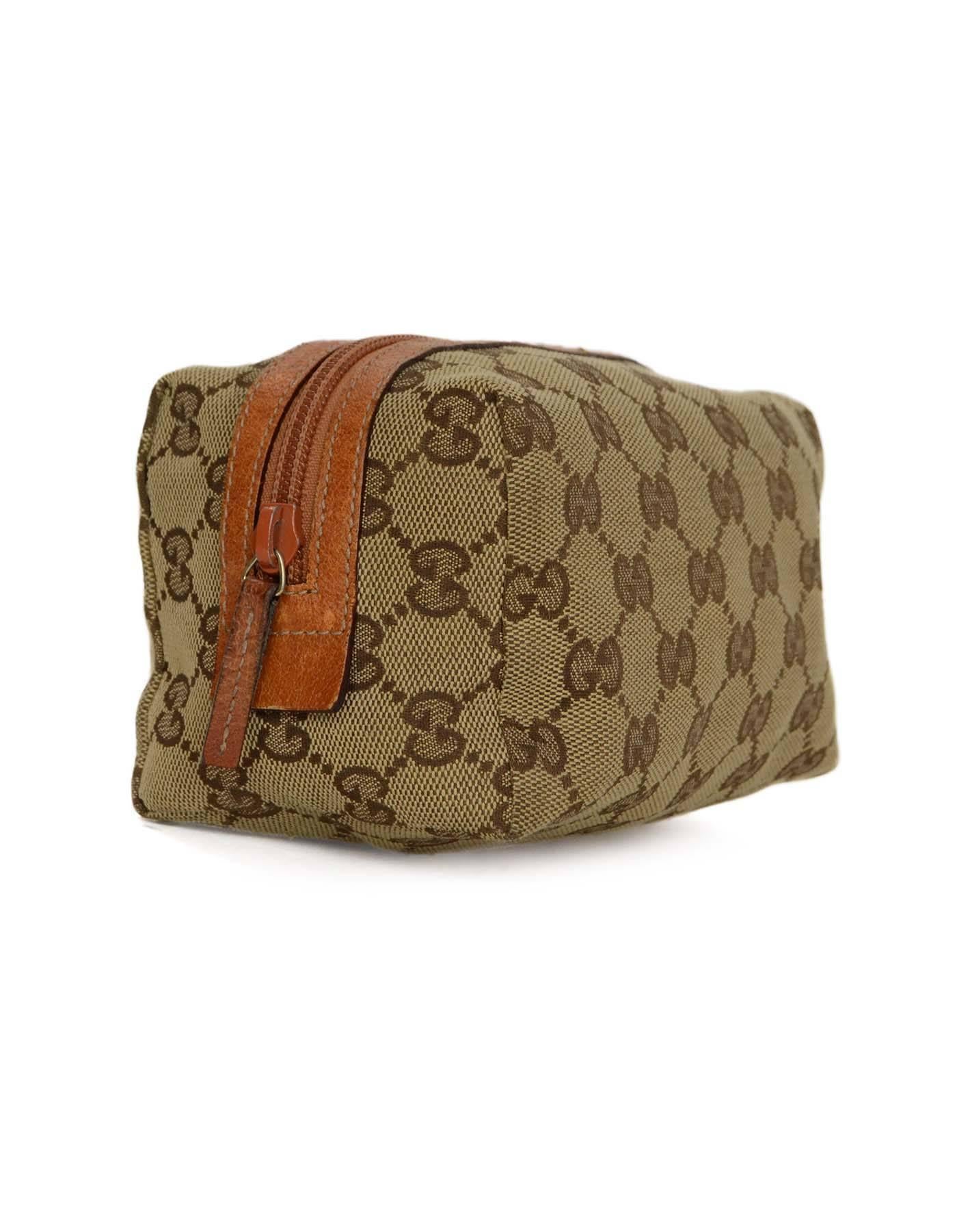 Features orange leather trim

-Made In: Italy
-Color: Tan and orange
-Materials: Canvas and leather
-Lining: Brown textile
-Closure/Opening: Zip top
-Exterior Pockets: None
-Interior Pockets: None
-Serial Number/Date Code: 29595