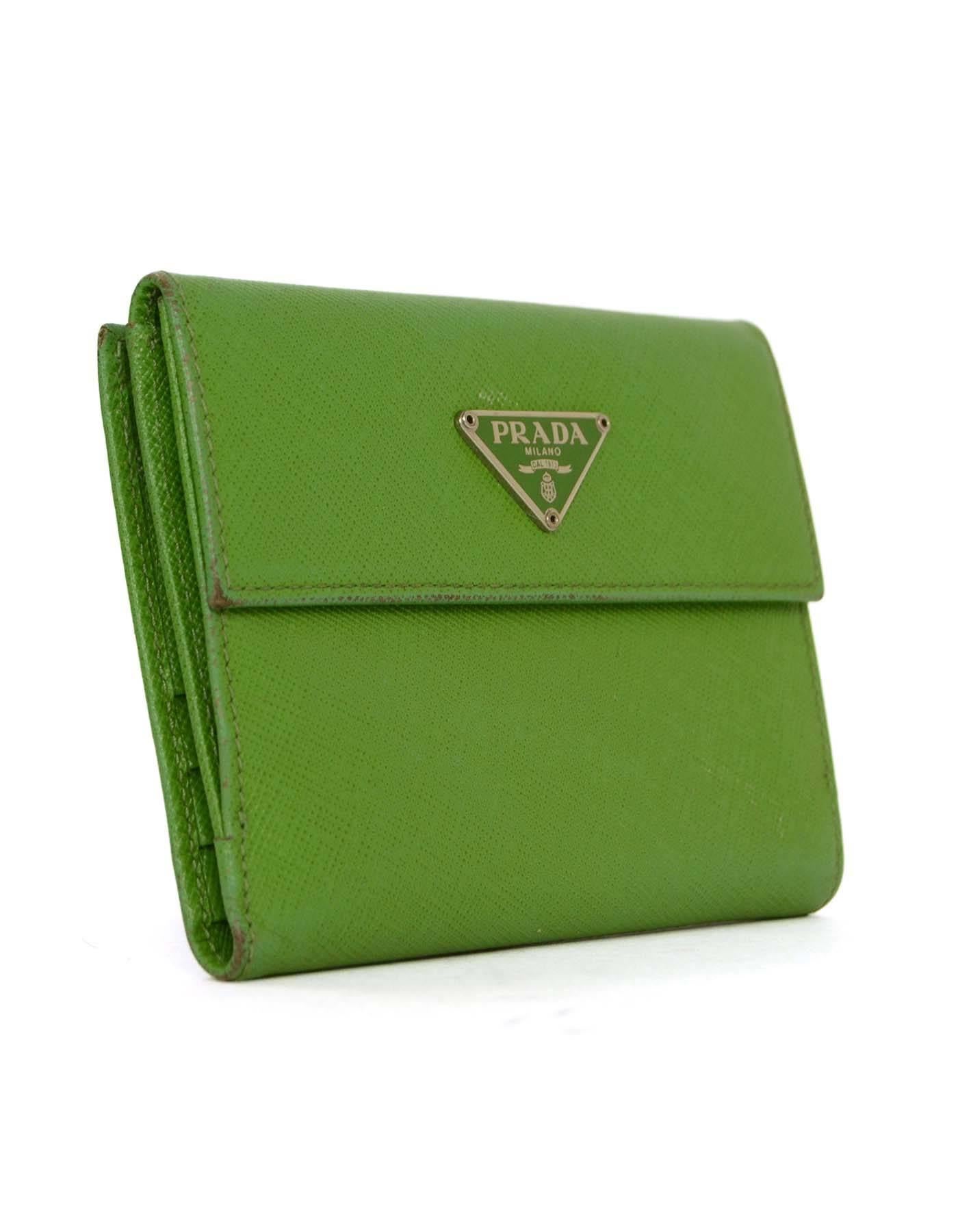 Prada Apple Green Saffiano Short Wallet 
Features green and silvertone Prada plate on front flap top
Made In: Italy
Color: Apple green
Hardware: Silvertone
Materials: Saffiano leather
Lining: Apple green saffiano leather
Closure/Opening: One
