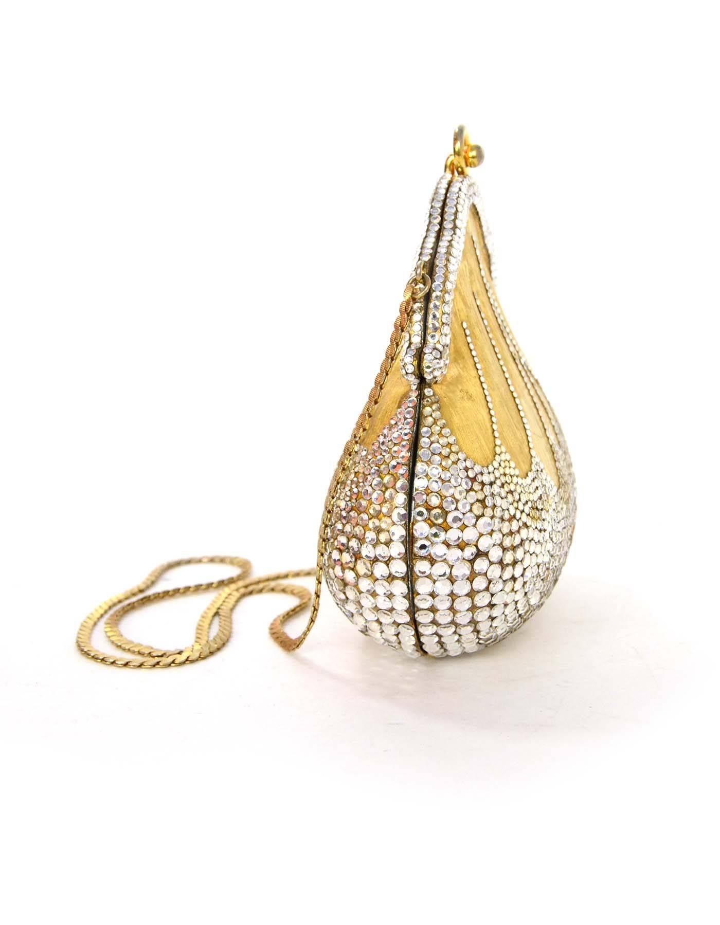 Judith Leiber Vintage '90s Crystal Minaudiere Evening Bag 
Year of Production: 1999
Color: Silvertone and goldtone
Materials: Metal and crystal
Lining: Metallic silver leather
Closure/Opening: Frame bag style opening
Exterior Pockets: