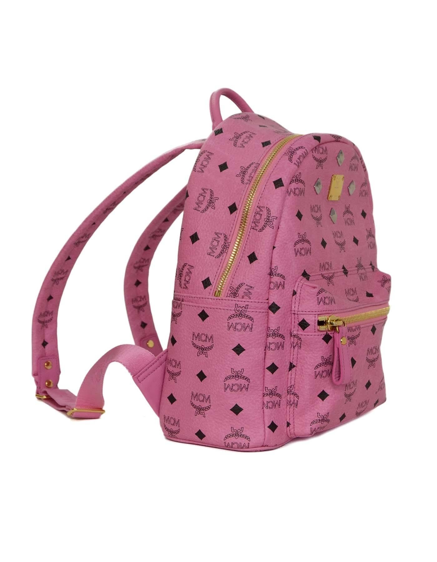 MCM Pink Leather Studded Backpack 
Features silvertone studs
Made In: Korea
Color: Pink and black
Hardware: Goldtone and silvertone
Materials: Leather
Closur/Opening: Double zip around closure
Exterior Pockets: One front zipper pocket and two