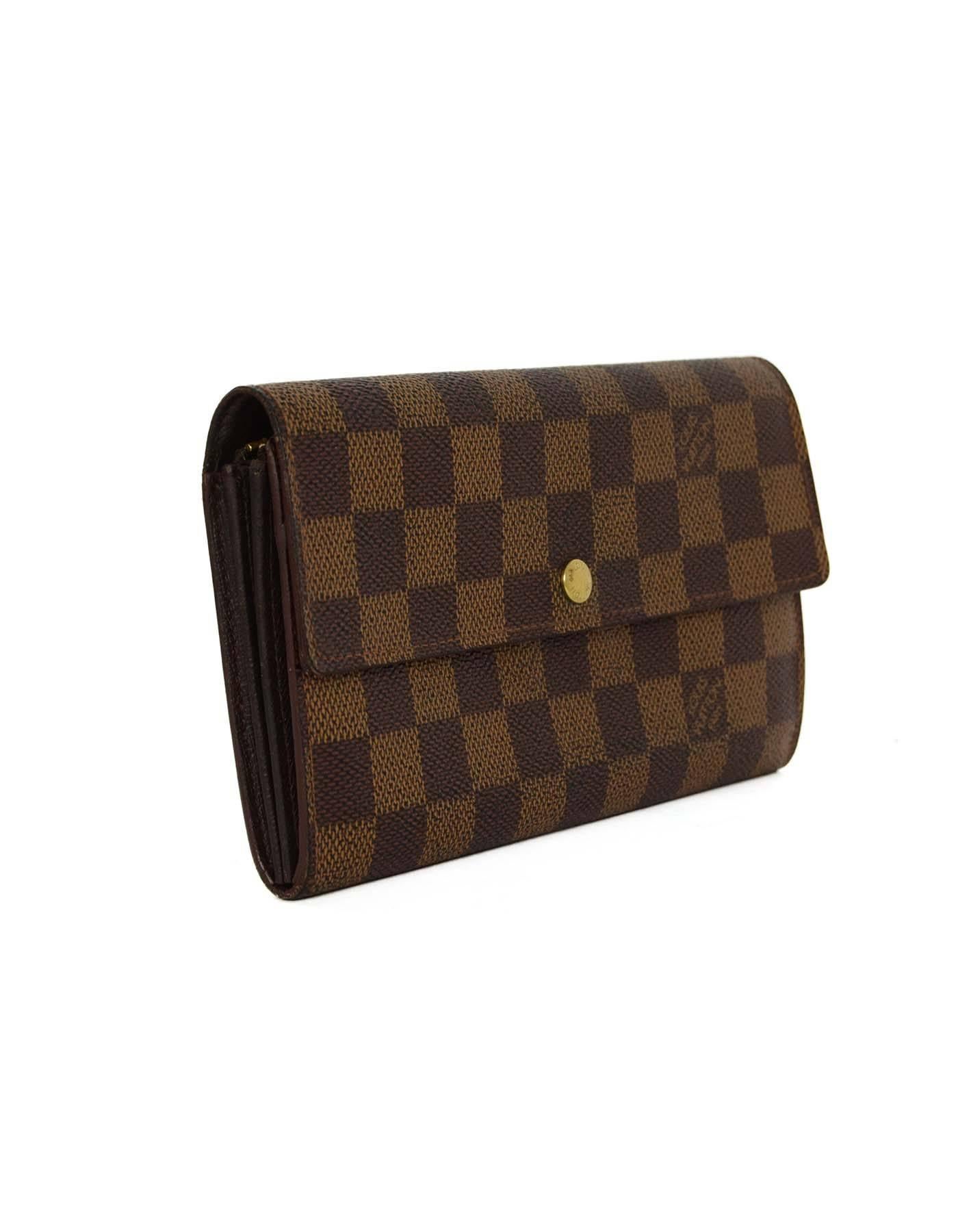 Louis Vuitton Vintage '97 Damier 'Sarah' Wallet 
Made In: Spain
Year of Production: 1997
Color: Brown
Hardware: Goldtone
Materials: Coated canvas
Lining: Brown coated canvas
Closure/Opening: Flap top with snap button closure
Exterior