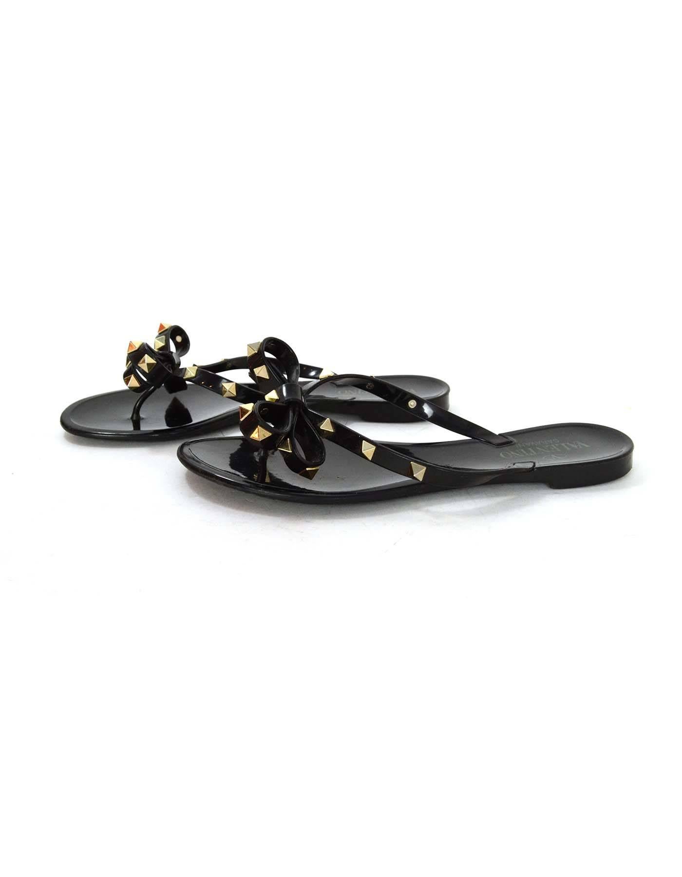 Valentino Black Studded Flip Flops 
Features rockstuds throughout
Made In: Italy
Color: Black
Hardware: Goldtone
Materials: Plastic and metal
Closure/Opening: Slip on
Sole Stamp: Valentino Garavani 37 Made in Italy
Overall Condition: Very