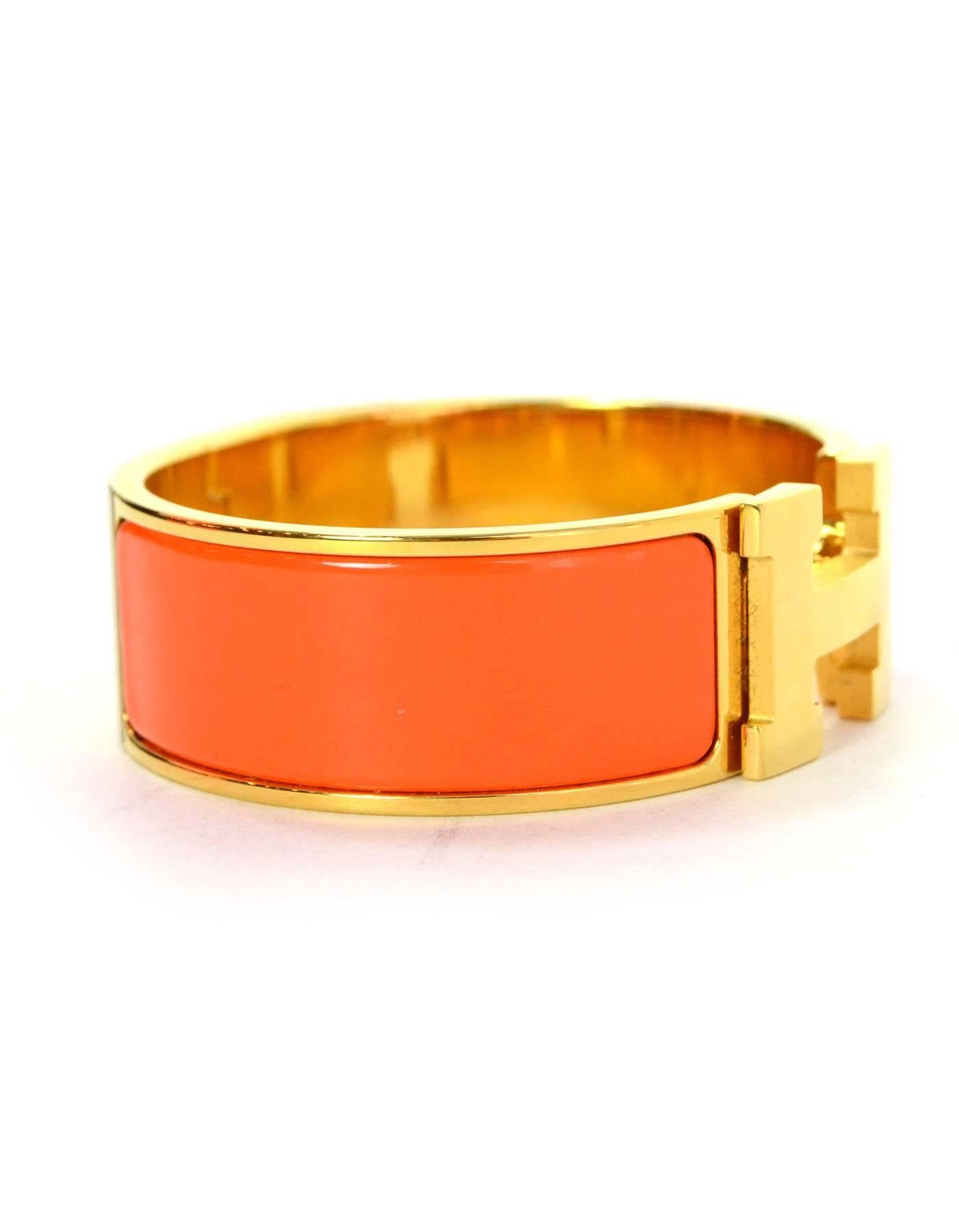Hermes Orange Enamel Wide H Clic Clac PM Bracelet 
Made In: France
Color: Orange
Hardware: Goldtone
Materials: Enamel and metal
Closure: H swivels with hinge opening
Stamp: Hermes P Made in France
Overall Condition: Excellent pre-owned