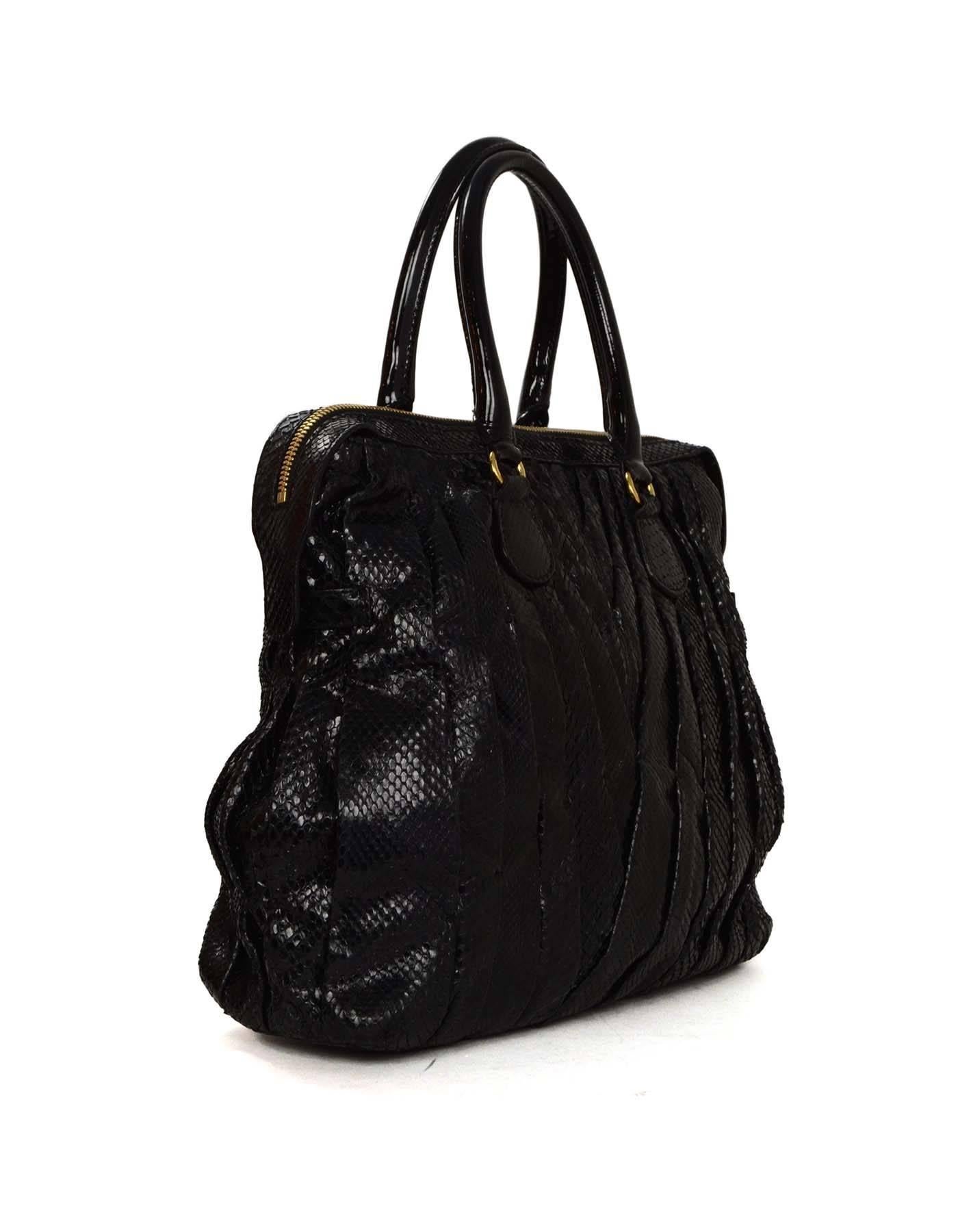 Valentino Black Snakeskin 'Maison Pintucked' Tote 
Features black patent leather wrapped handles

Made In: Italy
Color: Black
Hardware: Goldtone
Materials: Snakeskin
Lining: Red satin
Closure/Opening: Double zip across top
Exterior Pockets: