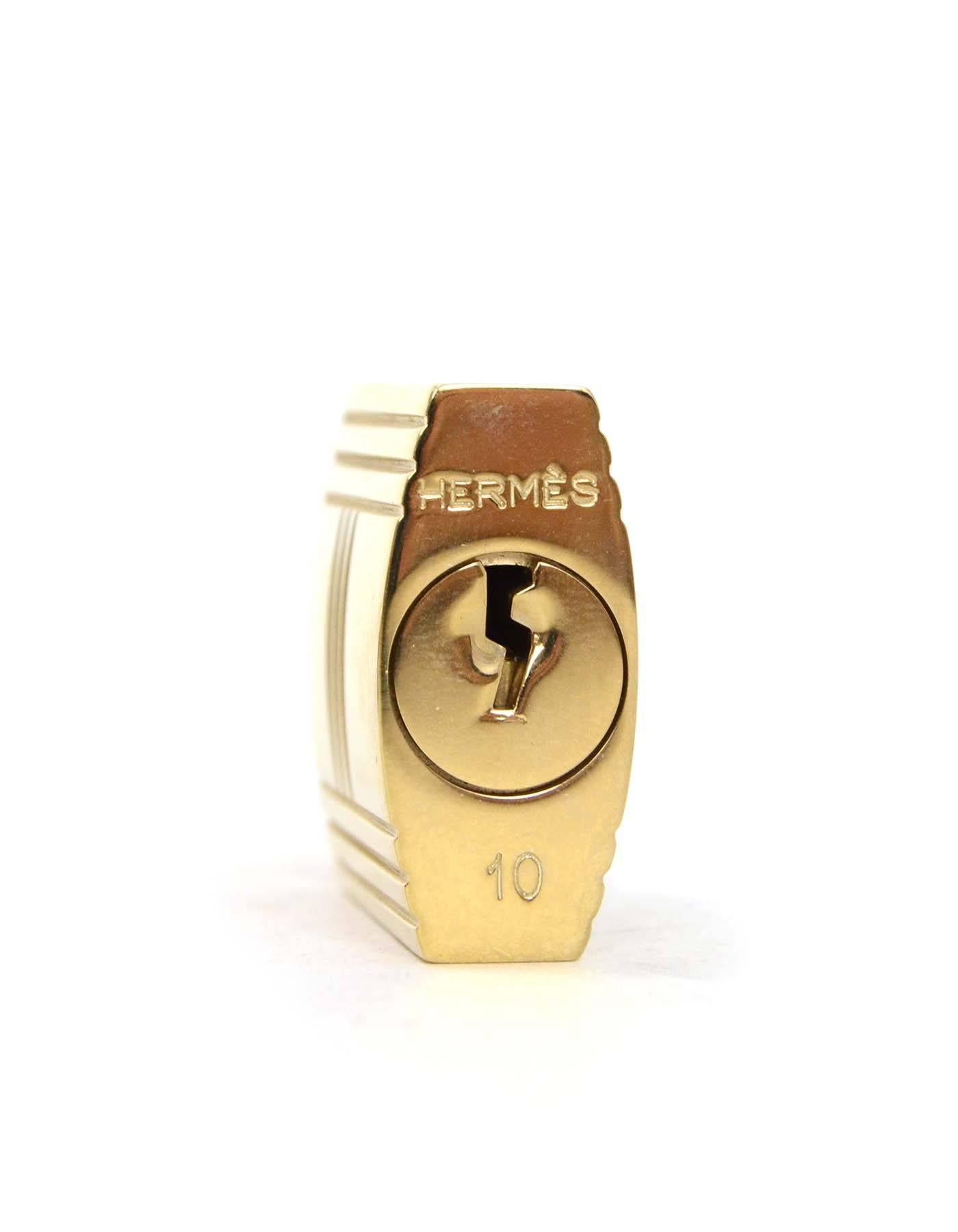 Hermes Large Gold Padlock & Keys
Color: Goldtone
Materials: Metal
Closure: Key lock
Stamp: Hermes 10
Overall Condition: Excellent 
Includes: Hermes pouch

Measurements: Padlock: 1.25
