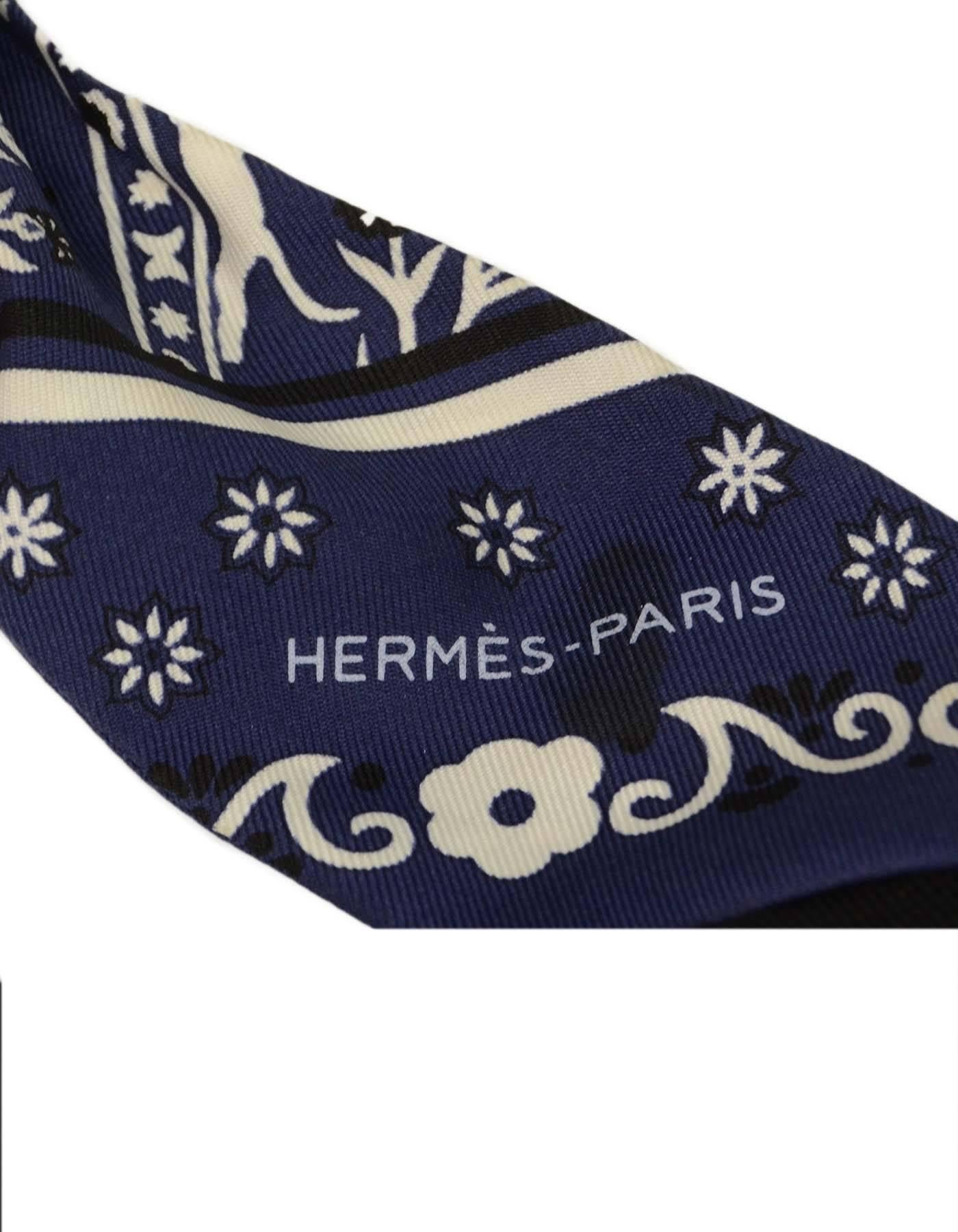 Hermes Navy Paisley Silk Print Twilly Scarf
Features paisley and horse combo print
Made In: France
Color: Navy, white, black
Composition: 100% Silk 
Overall Condition: Excellent pre-owned condition, with exception of light soiling on white