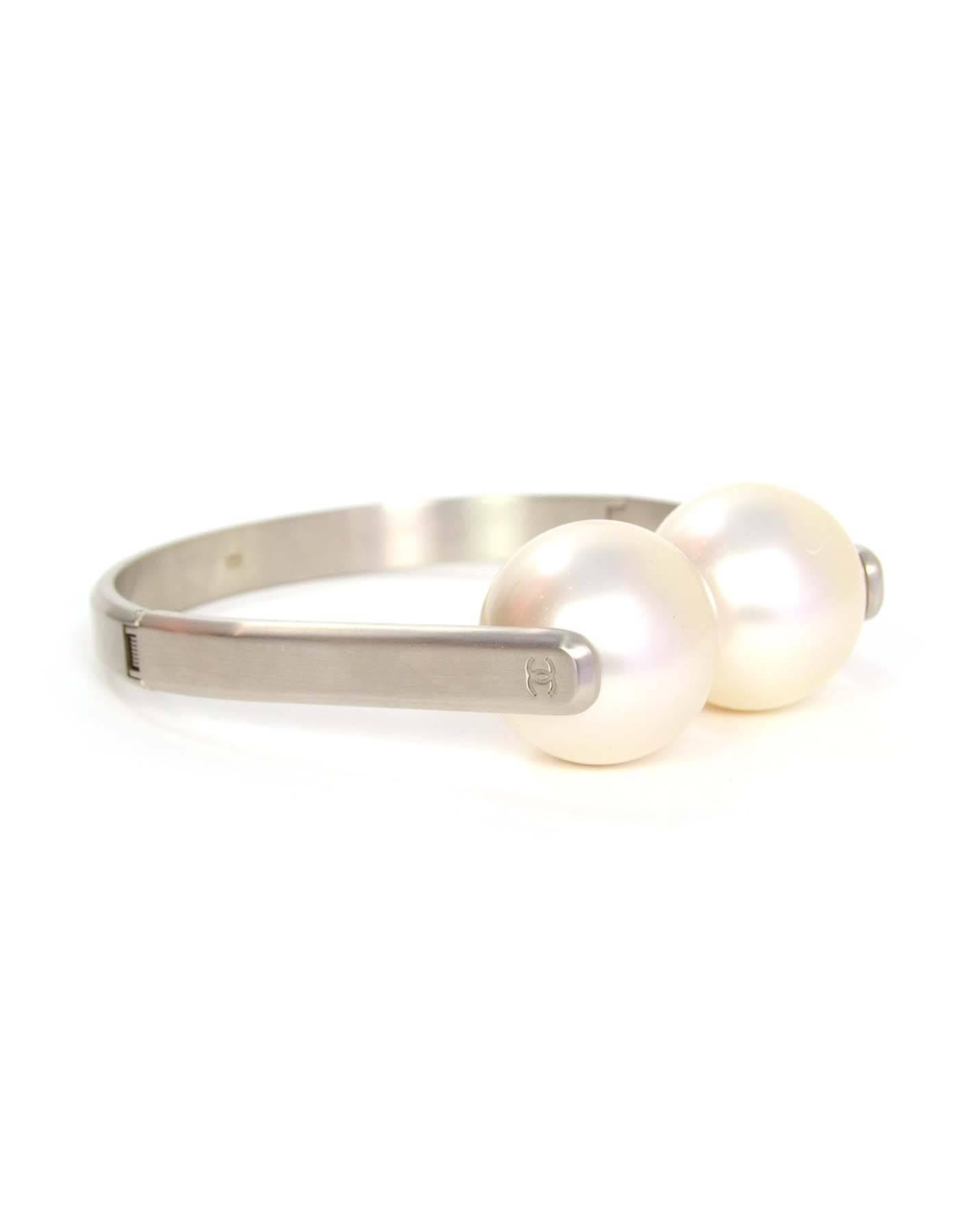 Chanel Silver & Ivory Jumbo Pearl Headphone Necklace 

Made In: France
Year of Production: 2014
Color: Light silvertone and ivory
Materials: Faux pearl and metal
Closure: Hinged sides
Stamp: A14 CC S
Overall Condition: Good pre-owned