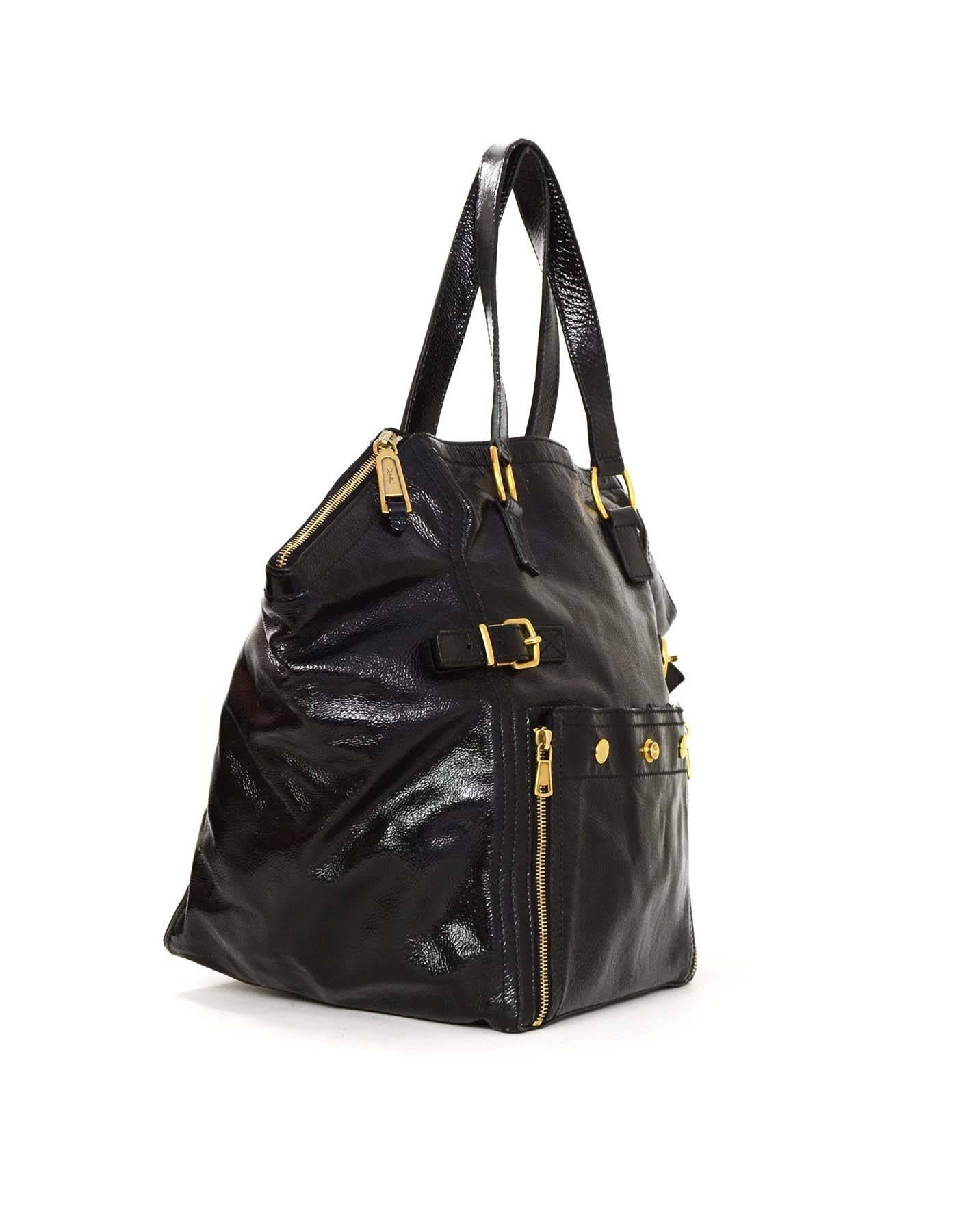 YSL Yves Saint Laurent Rive Gauche Large Black Patent Downtown Bag
Features two front buckle and notch detailing and exterior zipper and snaps kangaroo pocket 

Color: Black
Hardware: Goldtone
Materials: Black patent leather
Lining: Black silk