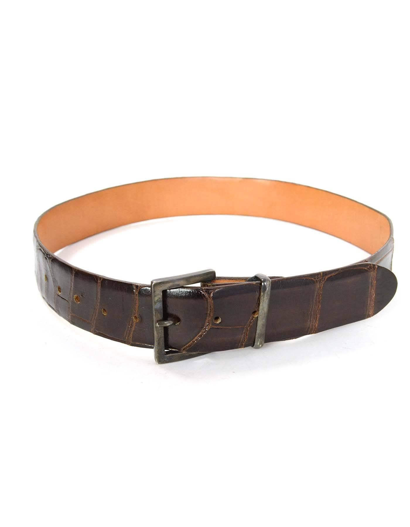 James Reid Brown Alligator Skin Belt 
Color: Brown
Hardware: Silvertone
Materials: Alligator skin
Closure/Opening: Buckle and notch closure
Stamp: James Reid, Ltd Genuine Alligator 32
Overall Condition: Excellent pre-owned condition with the