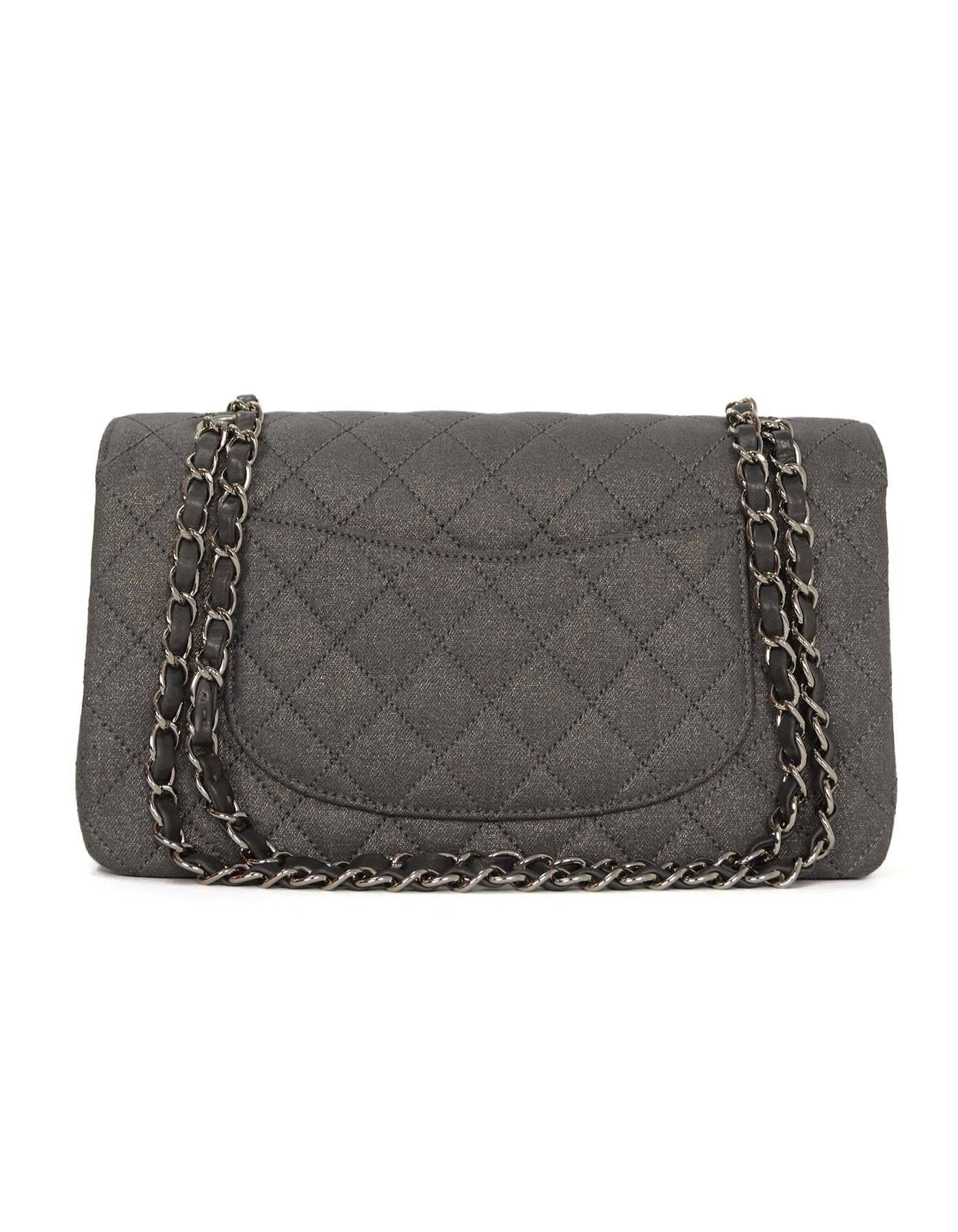 Chanel Metallic Grey Quilted Fabric Medium Classic Double Flap Bag
Features gold metallic threading throughout fabric
Made In: France
Year of Production: 2005-2006
Color: Metallic grey
Hardware: Silvertone
Materials: Fabric
Lining: Grey
