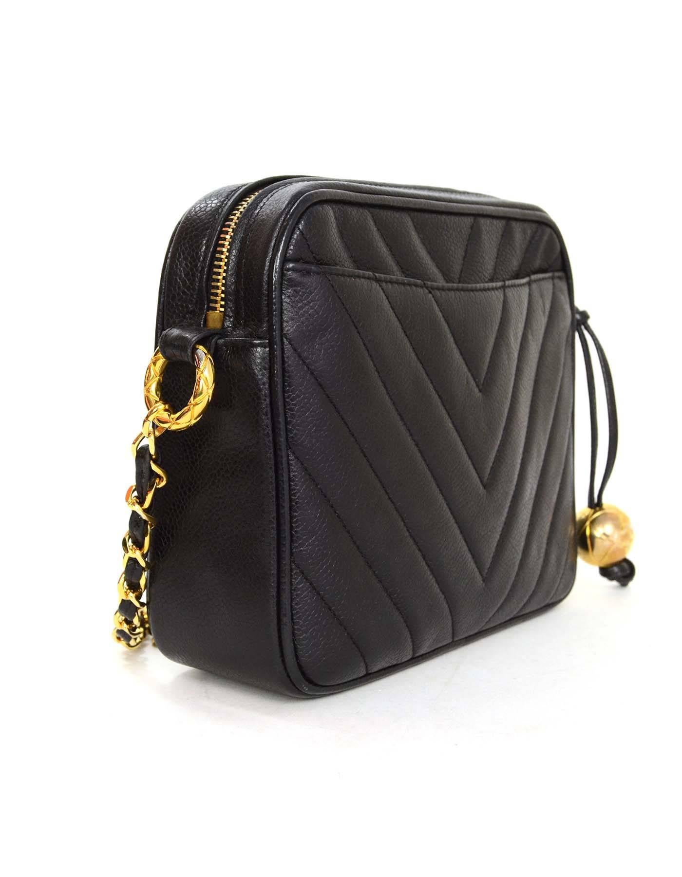 Chanel Vintage '93 Black Chevron Caviar Leather Camera Bag
Features quilted round charm pull 
Made In: Italy
Year of Production: 1993
Color: Black
Hardware: Goldtone
Materials: Caviar leather
Lining: Black leather
Closure/Opening: Top
