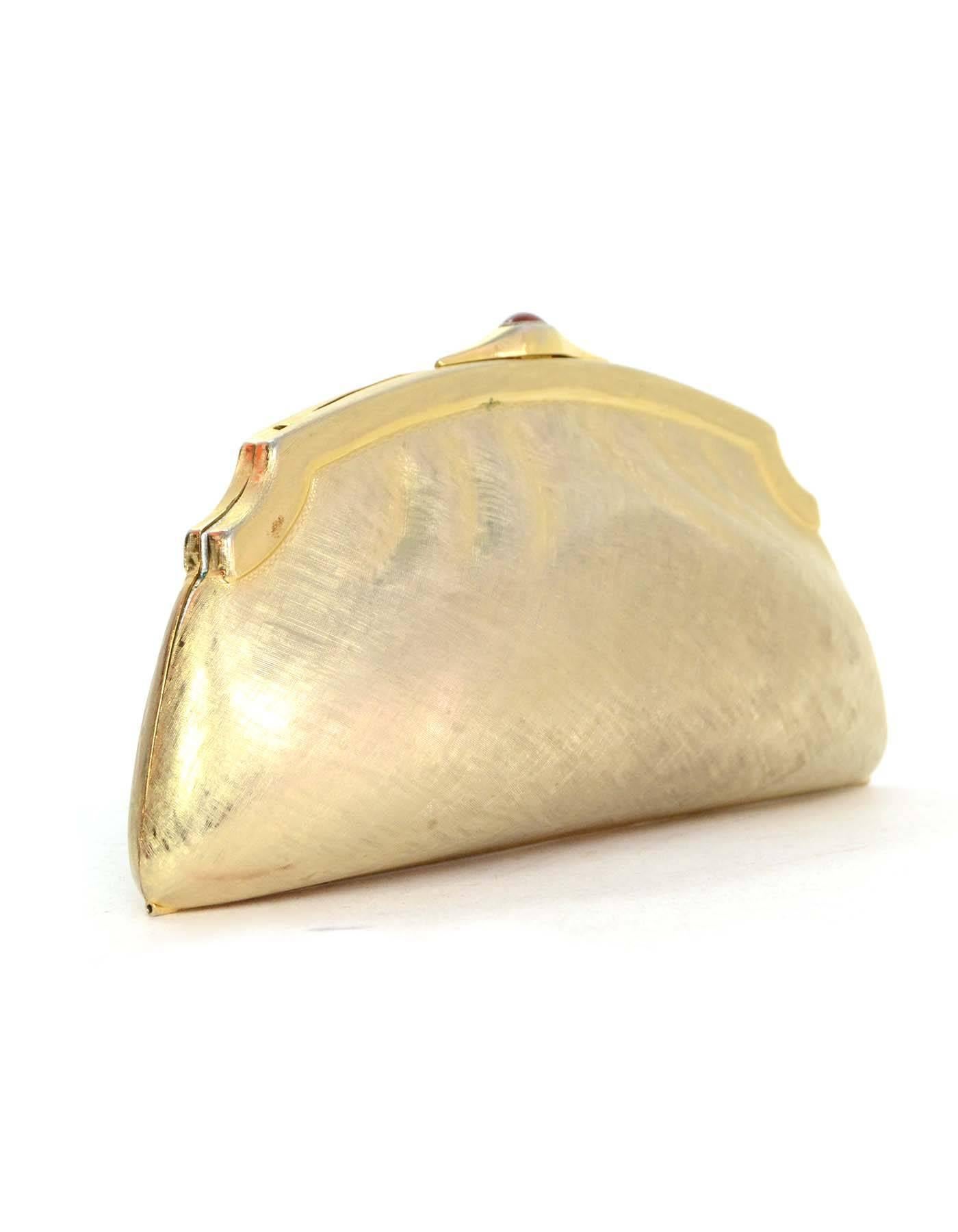 Judith Leiber Textured Gold Clutch
Features optional shoulder strap
Color: Goldtone
Hardware: Goldtone
Materials: Metal 
Lining: Metallic silver leather
Closure/Opening: Carnelian top push lock
Exterior Pockets: None
Interior Pockets: