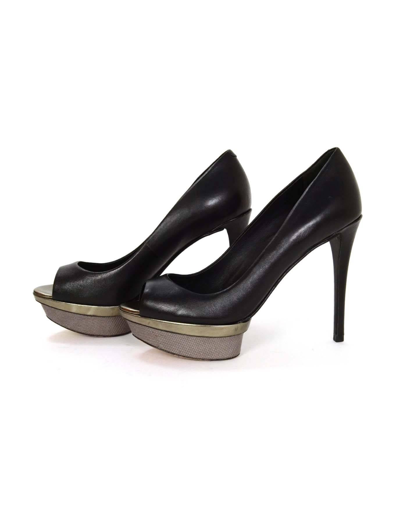 Brian Atwood Black Leather Peep-Toe Platform Pumps 
Features metallic textured platform
Made In: China
Color: Black and silver
Materials: Leather
Closure/Opening: Slide on
Sole Stamp: Brian Atwood Vero Cuoio 6
Overall Condition: Excellent