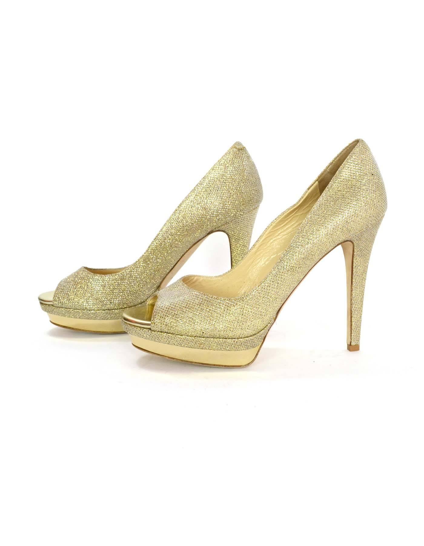 Jimmy Choo Gold Glitter Peep-Toe Platform Pumps
Made In: Italy
Color: Gold
Materials: Mesh and leather
Closure/Opening: Slide on
Sole Stamp: Jimmy Choo London Made in Italy 40
Overall Condition: Excellent pre-owned condition with the exception