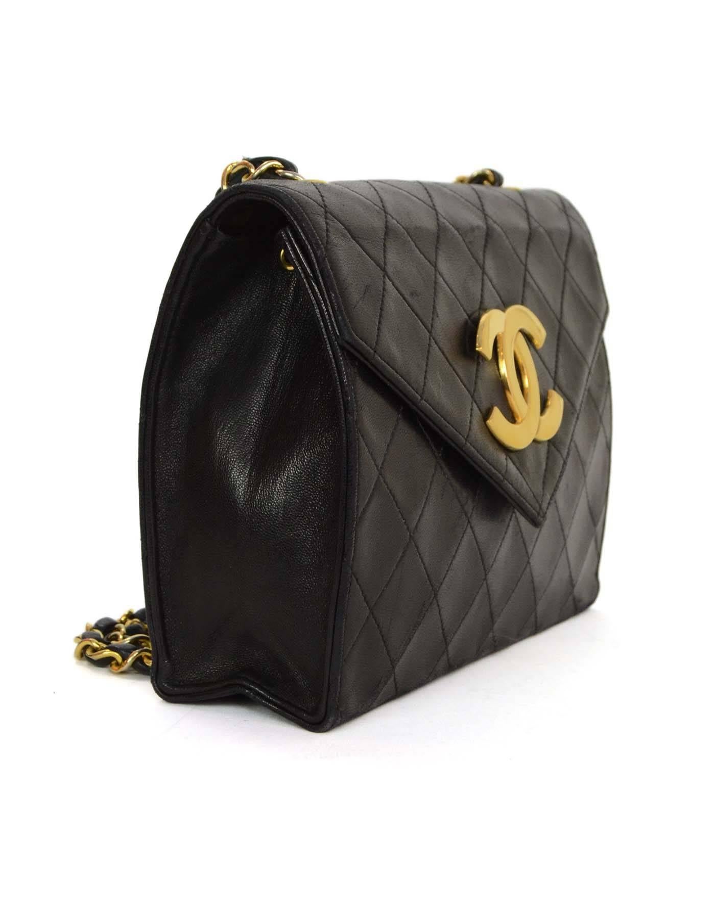 Chanel Black Quilted CC Flap Bag 
Features envelope flap with CC logo hardware detail

Year of Production: 1988
Color: Black
Hardware: Goldtone
Materials: Leather and metal
Lining: Burgundy leather
Closure/Opening: Snap closure
Exterior