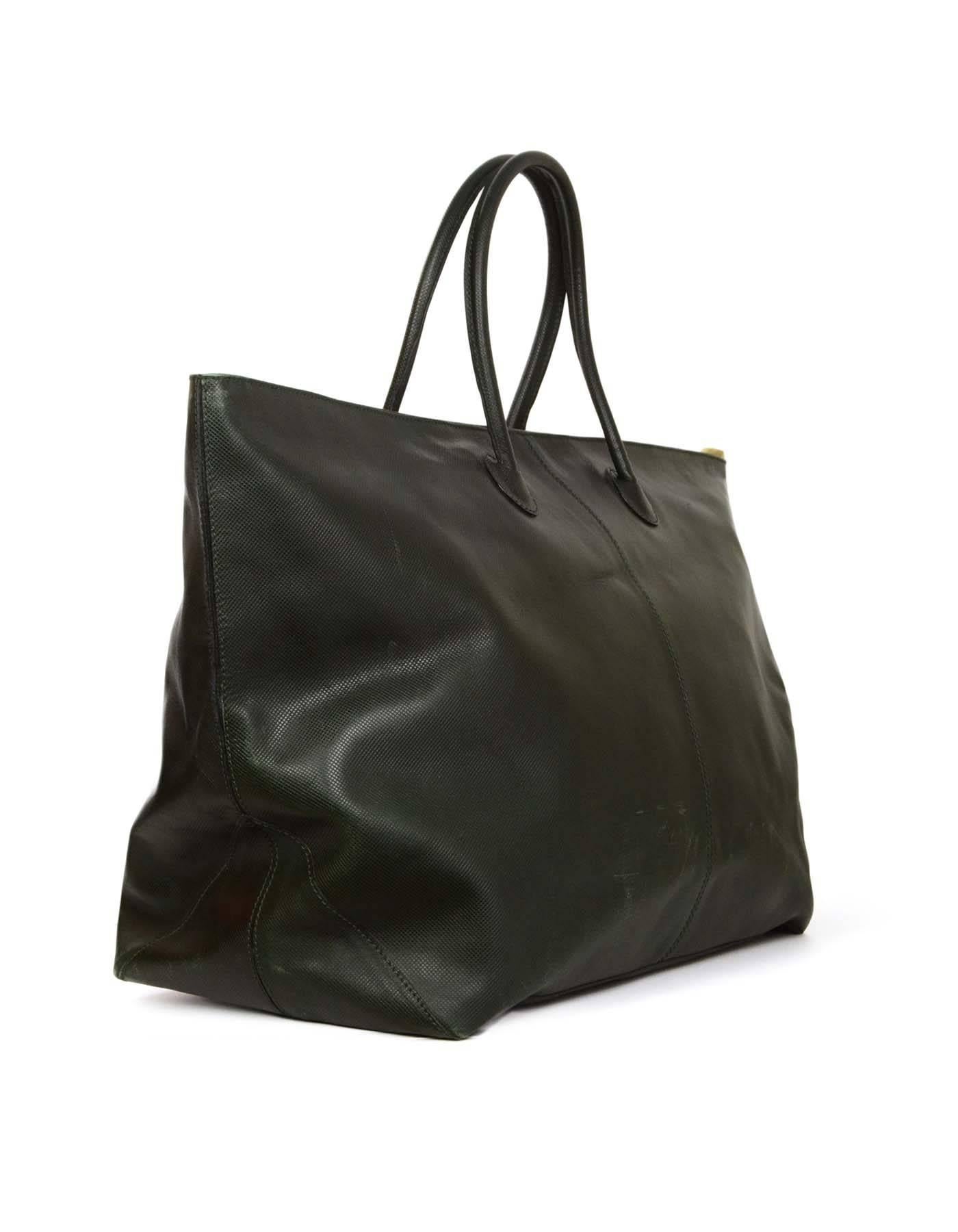 Bottega Veneta Forest Green XL Tote 
Features two key detailing by top handles

Made In: Italy
Color: Forest green
Hardware: Goldtone
Materials: Leather
Lining: Peach textile
Closure/Opening: Lock zipper pull closure 
Exterior Pockets: