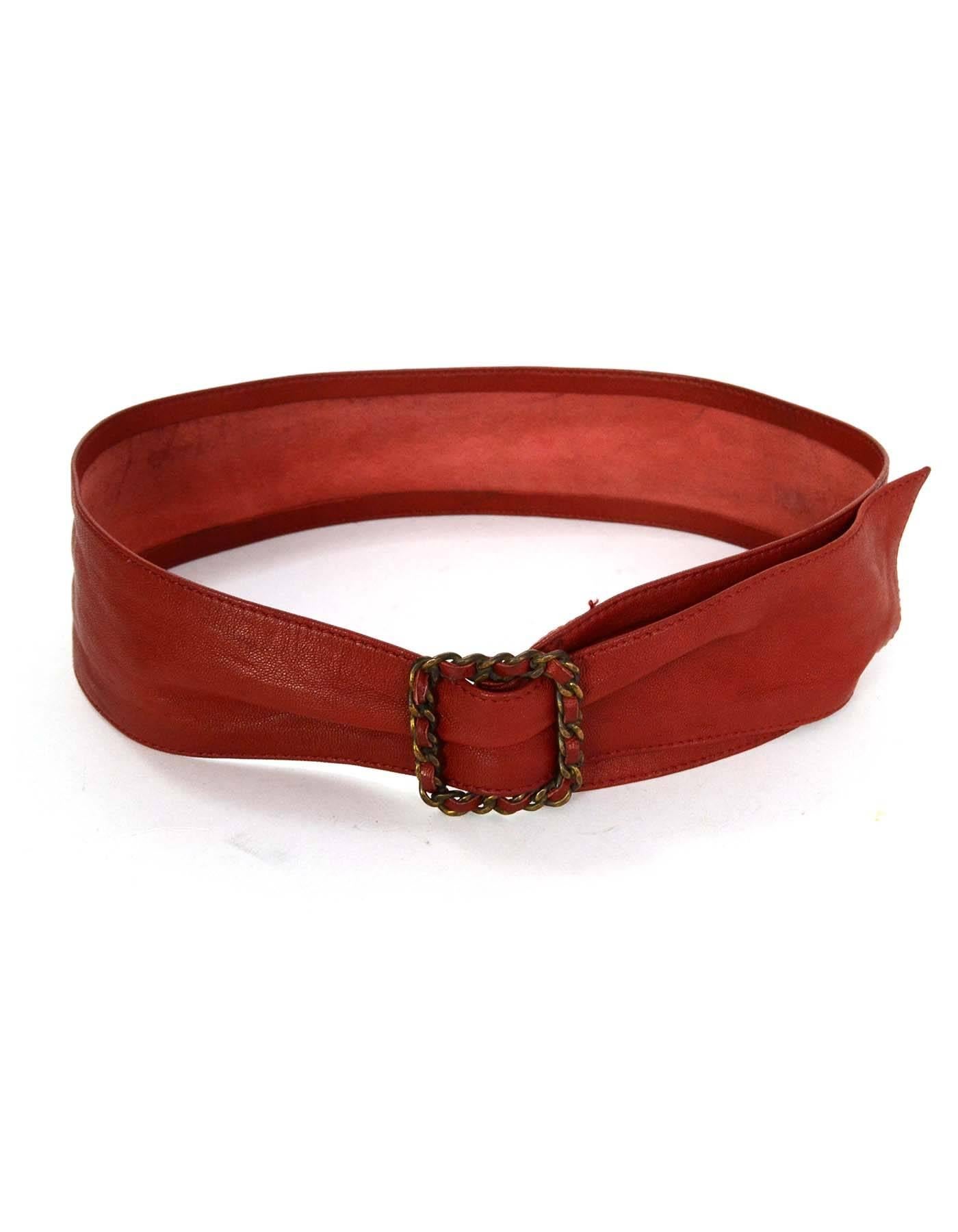 Chanel Red Leather Sash Belt 
Features red leather woven brass chain link belt buckle
Color: Red
Hardware: Brass
Materials: Leather and metal
Closure/Opening: Adjustable belt buckle
Stamp: Chanel
Overall Condition: Very good vintage,