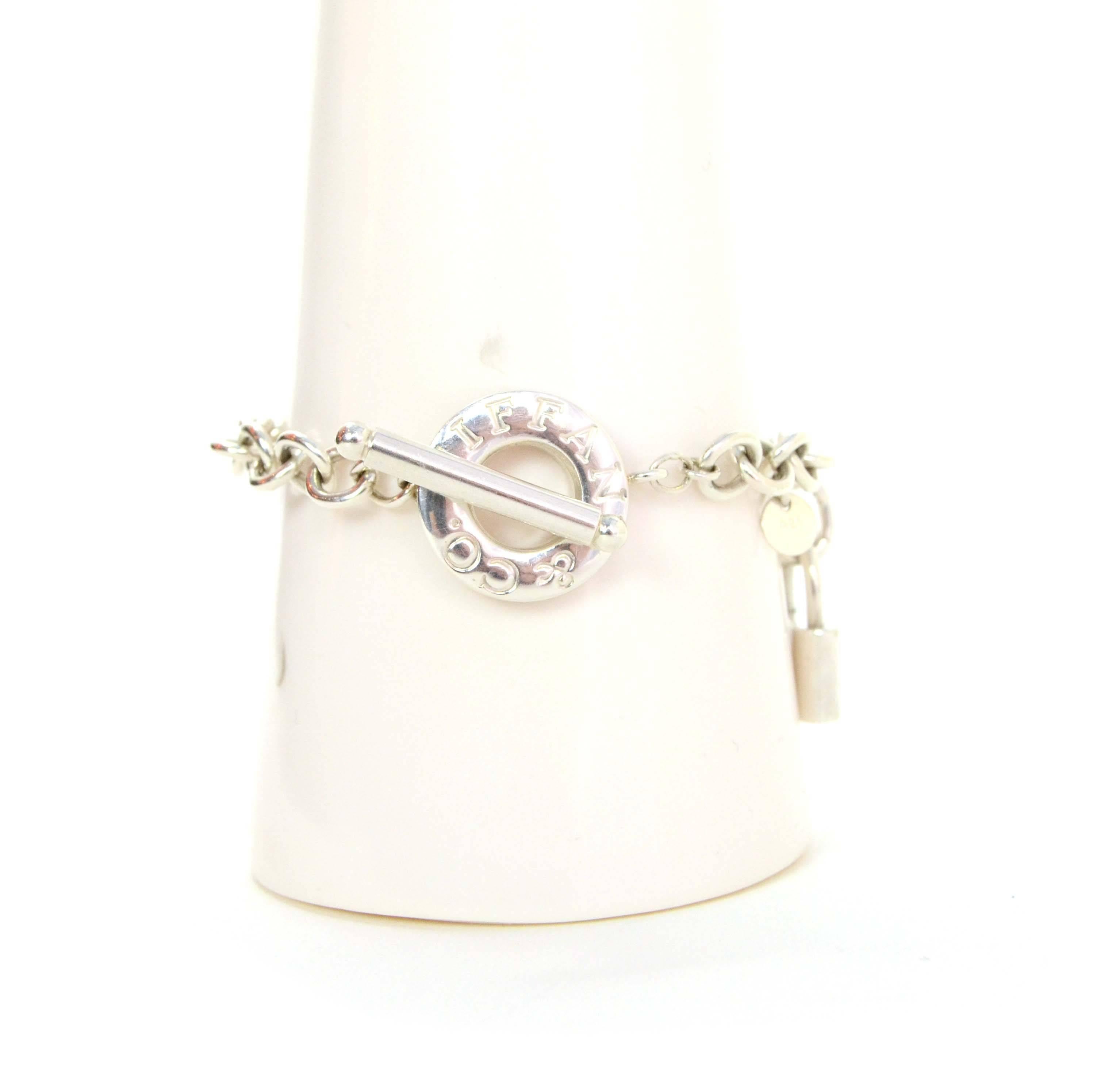 Tiffany & Co. Sterling Lock & Toggle Bracelet

Made In: Italy
Color: Silver
Materials: Sterling silver
Closure: Toggle closure
Stamp: T&Co. Ag 925 Italy
Retail Price: $275 + tax
Overall Condition: Excellent pre-owned condition with the