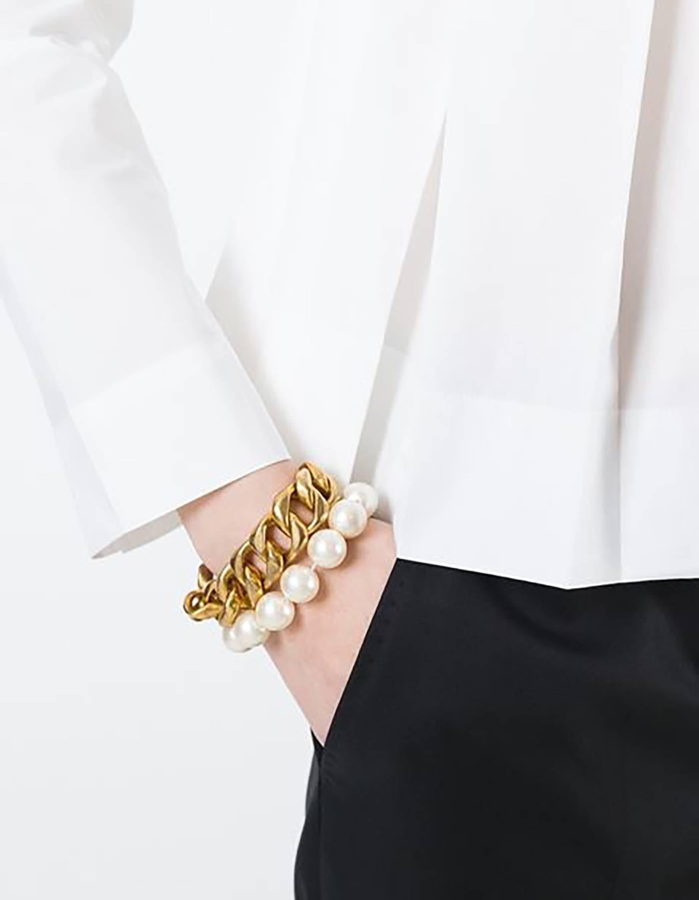 Chanel Pearl & Bronze Chain Link Bracelet
Made in: France
Year of Production: 1980s
Color: Goldtone and ivory
Materials: Metal and faux pearl
Closure: Antique push lever closure
Stamp: Chanel CC Made in France
Overall Condition: Excellent